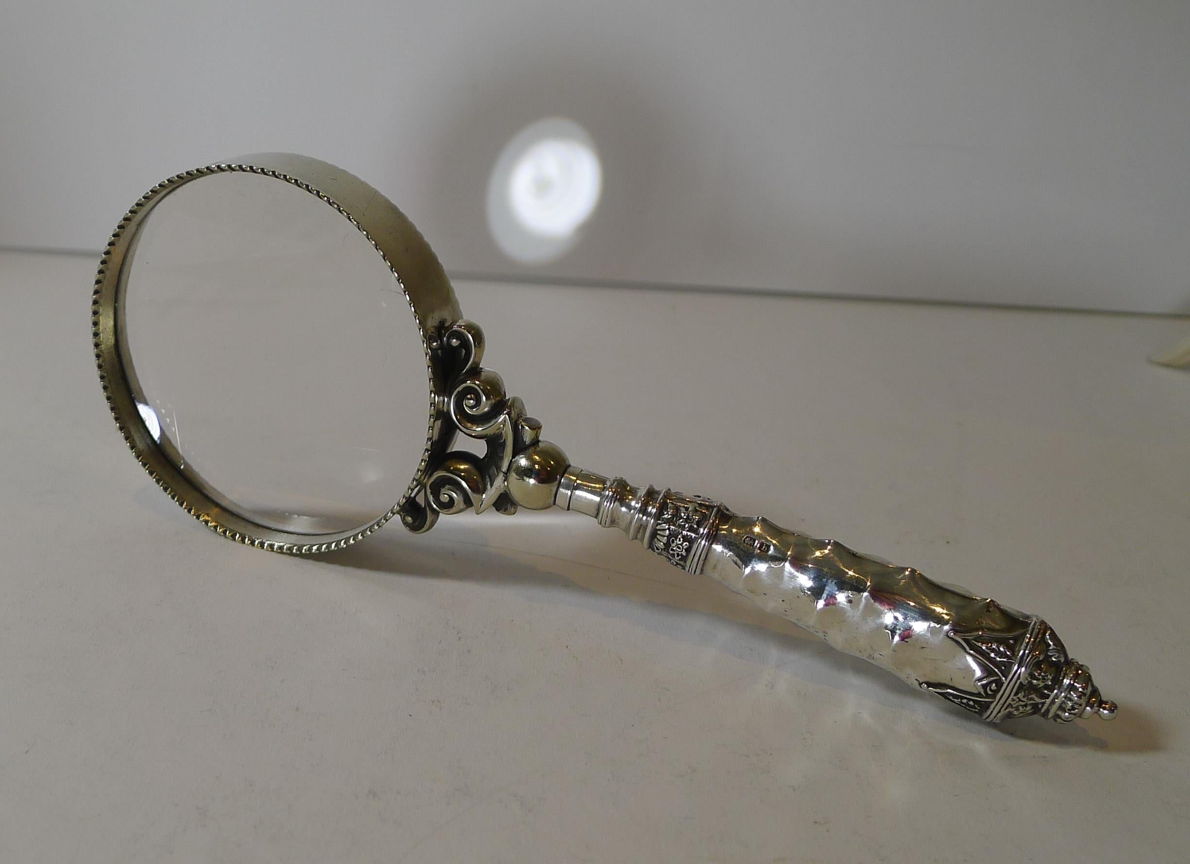 A lovely original magnifying glass with a highly decorative handle made from sterling silver fully hallmarked for Birmingham 1907 together with the maker's mark for the well renowned silversmith, Crisford and Norris.

The glass is original