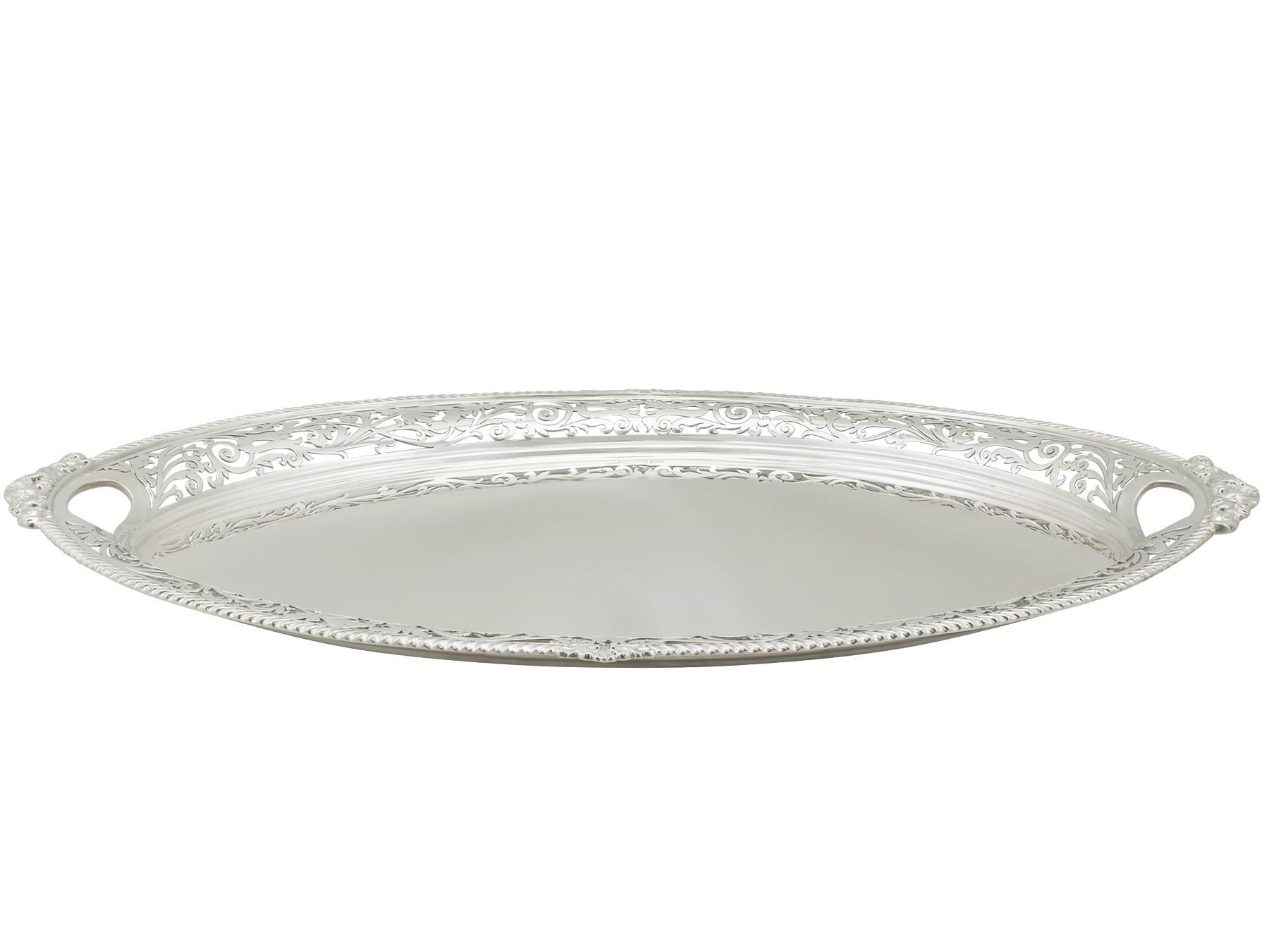 A fine, large and impressive antique Edwardian English sterling silver two-handled tea tray; an addition to our silverware collection.

This fine antique Edwardian sterling silver tea tray has an oval navette shaped form.

The surface of this