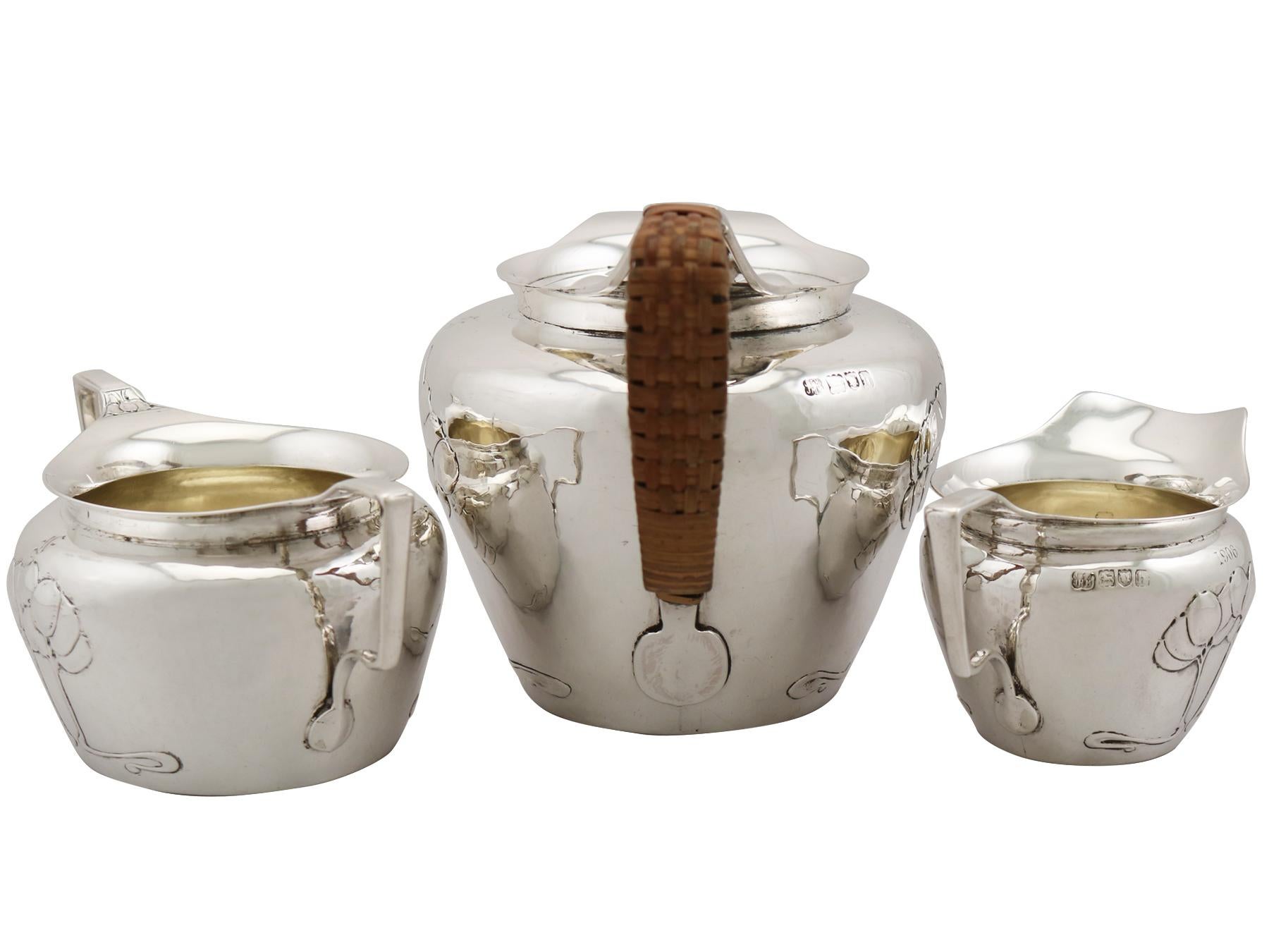 An exceptional, fine and impressive, unusual antique Edwardian English sterling silver three piece tea service in the Art Nouveau style; an addition to our antique teaware collection.

This exceptional antique Edwardian sterling silver three piece