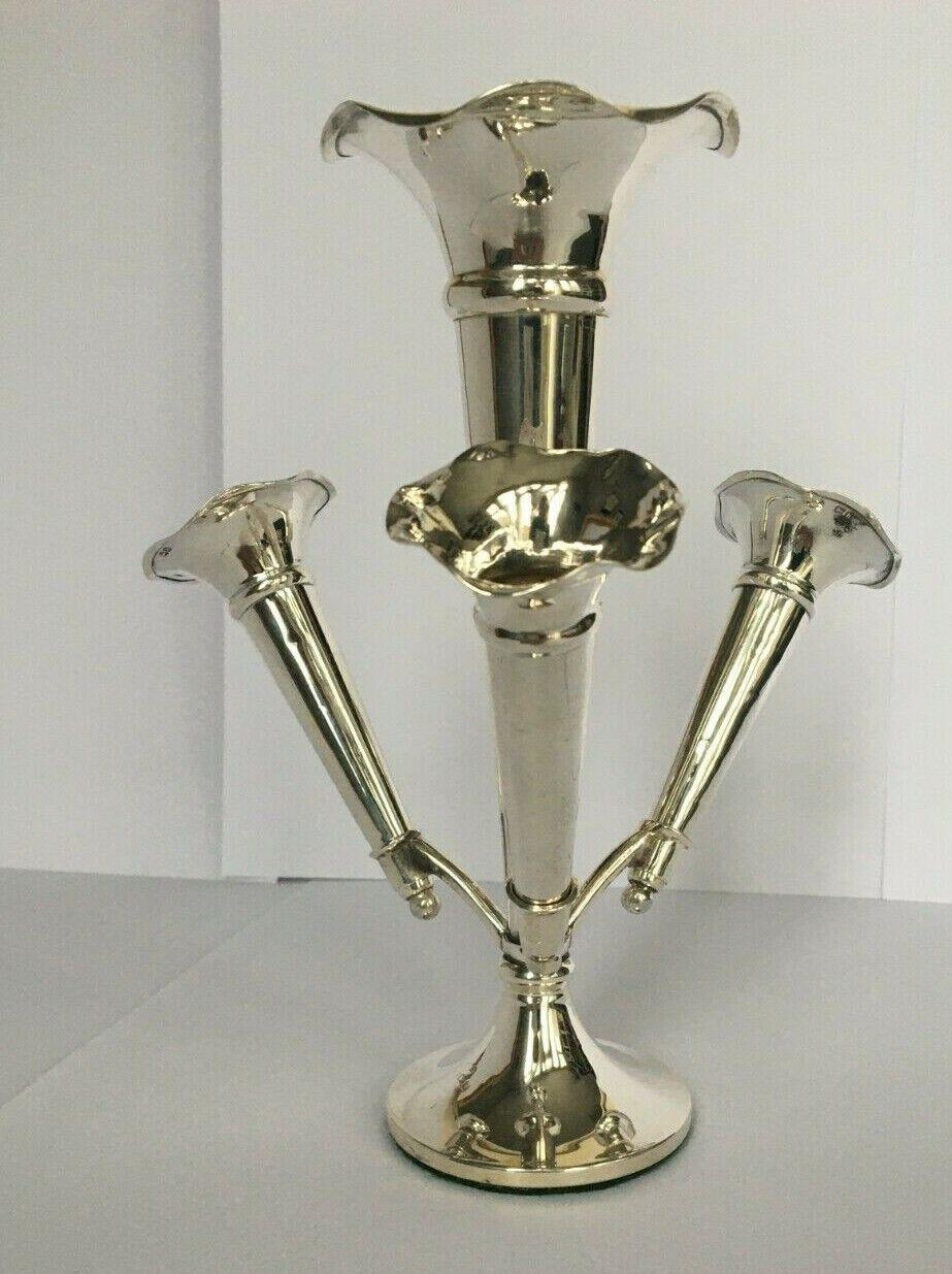 Edwardian Sterling Silver Epergne Made in London in 1903

In very good condition, the vases have flared tops. The holder has a filled base for stability. The base is covered with green felt. It has three three small vases. The small vases have some
