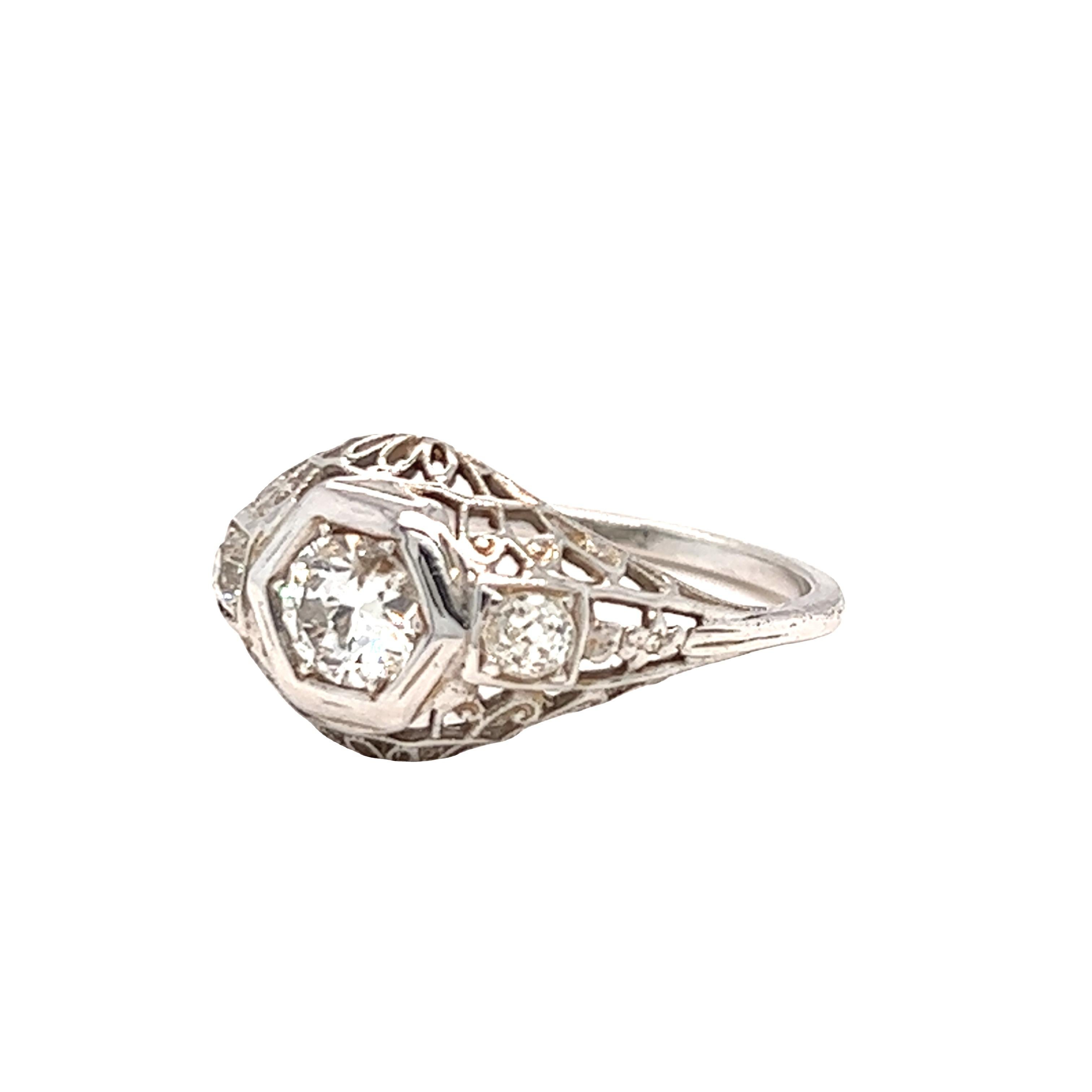 Centering in this beautiful Edwardian era ring is an Old European cut diamond weighing approximately 0.75 carat H color and SI clarity. The side diamonds accent the center stone collectively weigh 0.15 carat. The ring is crafted in 14k white gold