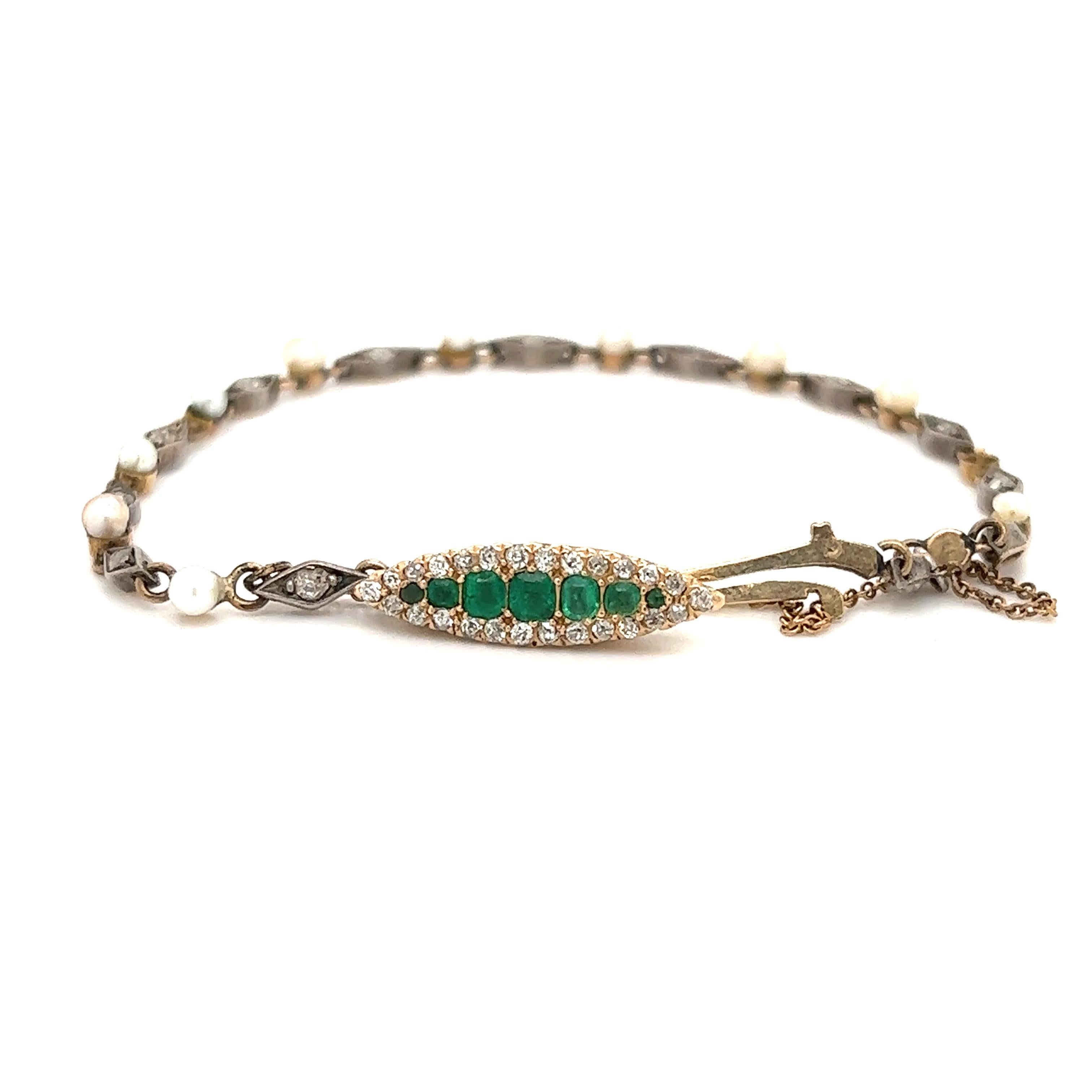 Equisite details seen on this beautiful Edwardian era bracelet. The bracelet is crafted in gold & silver. The focal point of the bracelet is the center navette station which is set with old mine cut diamonds and emerald gemstones. The diamonds &