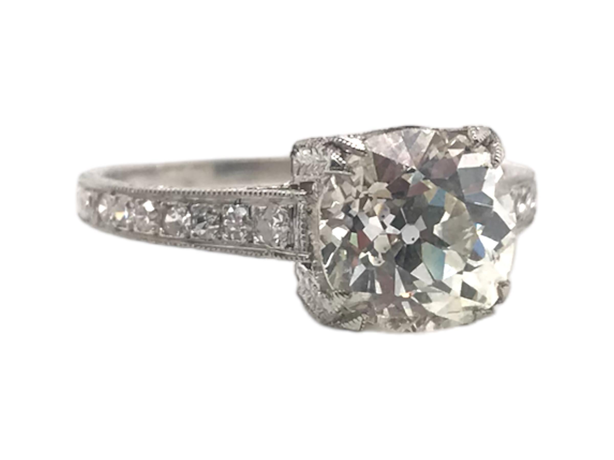 We always love a vintage solitaire style engagement ring!
This beauty is no exception!
This lovely ring is in pristine condition and is accented with fine engraving details and subtle diamond accents.

Diamond Details
Cut: Old Mine 
Weight: 2.21