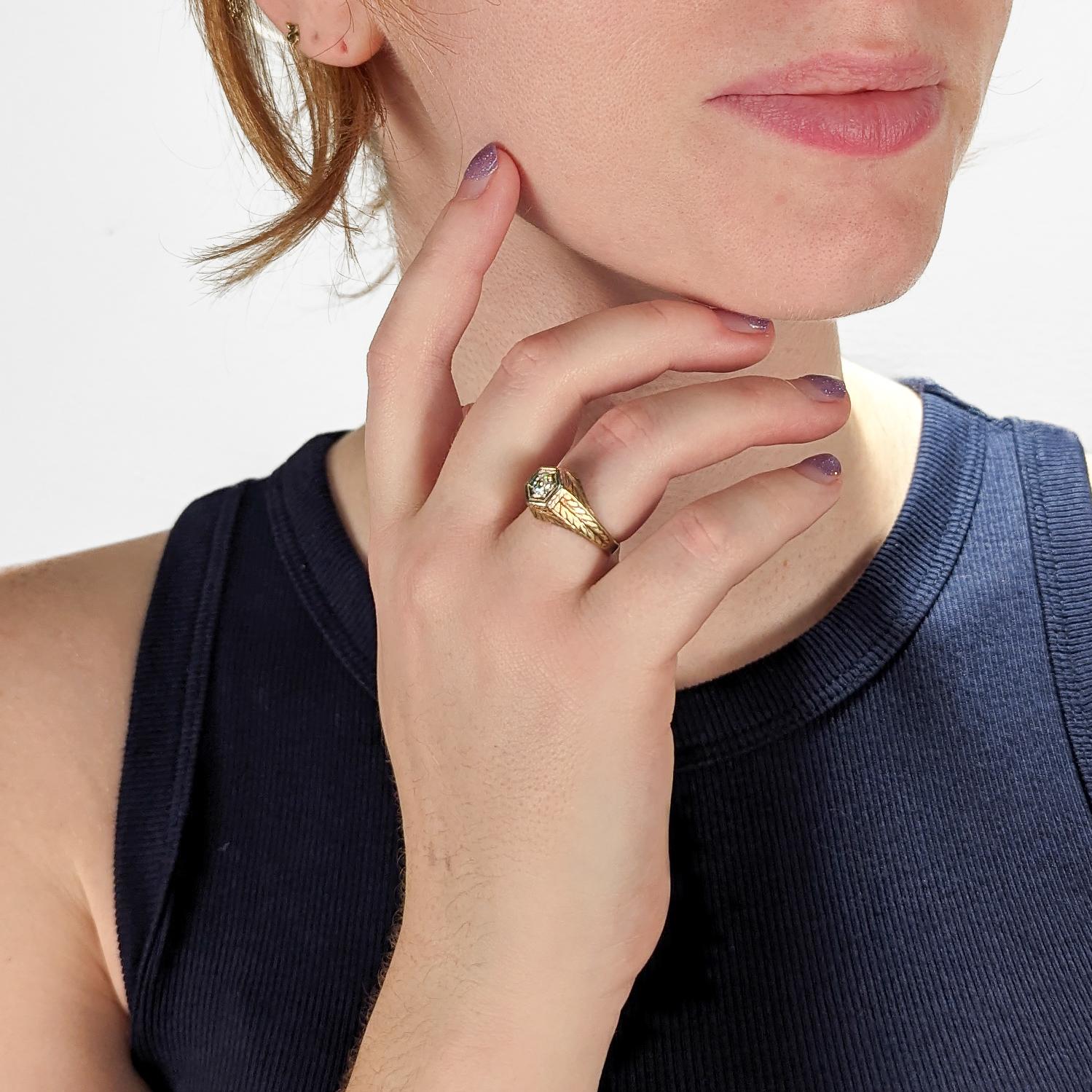 A very fine antique engraved 14k gold and diamond ring.

With a lovely ca. 0.24 ct. Old European cut diamond (Color: G /Clarity: I1) set at the center of a hexagonal setting that is engraved with a feathered design to the band and