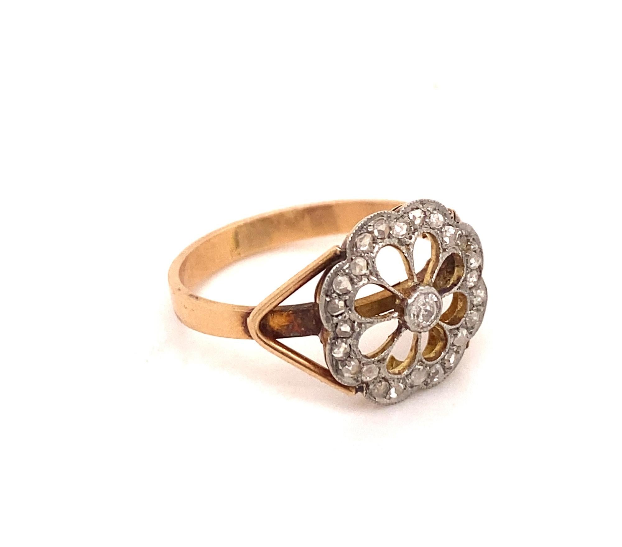 This is a beautiful original Edwardian ring c.1910. The ring has a flower like design with 1 old mine and 20 rose cut diamonds set in platinum with an 18K gold ring shank. The center diamond measures .07 carats total weight .50 carats I color SI-1