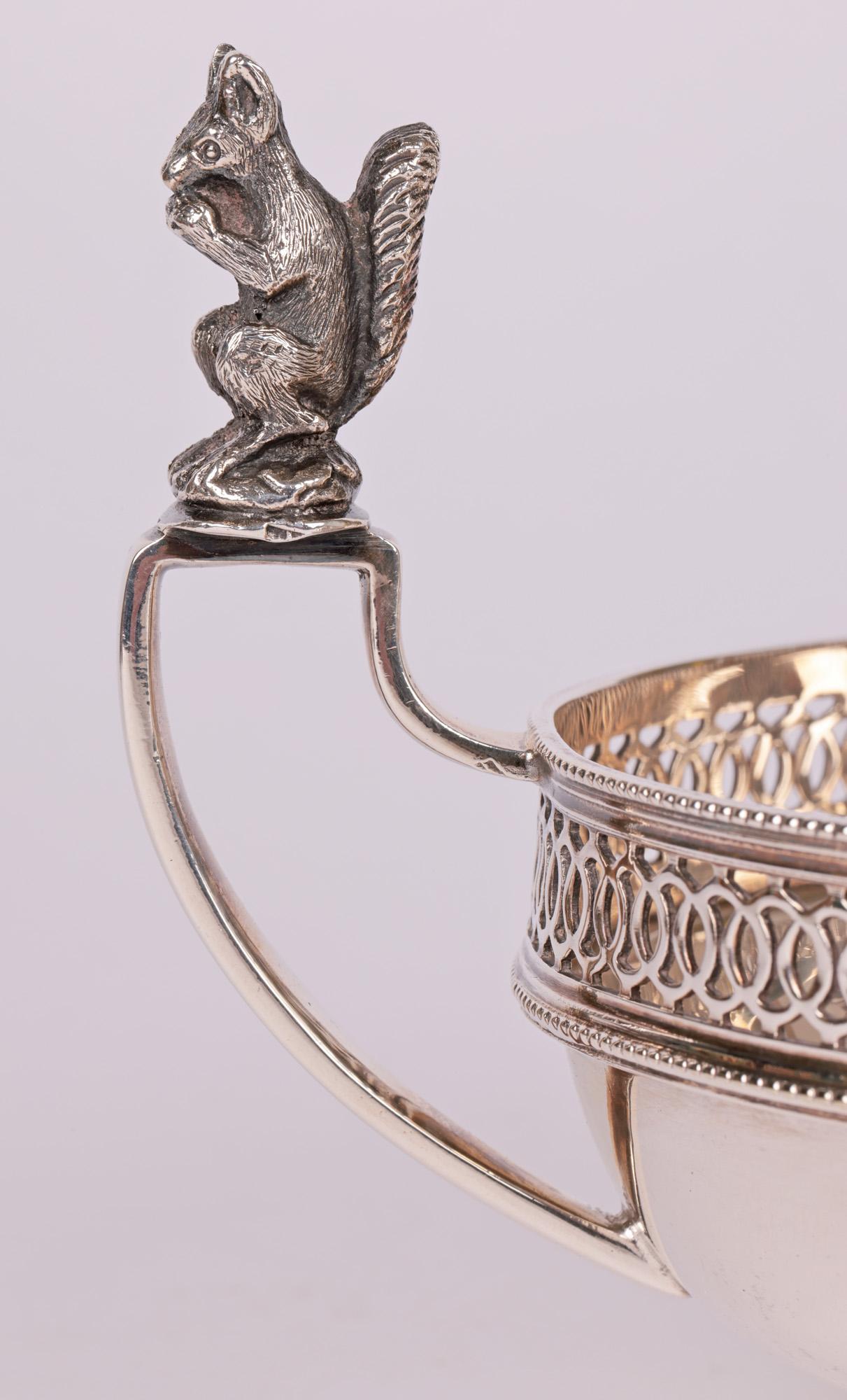 An unusual quality Edwardian English silver plate twin handle nut dish the handles mounted with squirrels by Charles S Green, Birmingham and made around 1905. The dish is of oval shaped standing raised on a narrow oval pedestal base with a circle