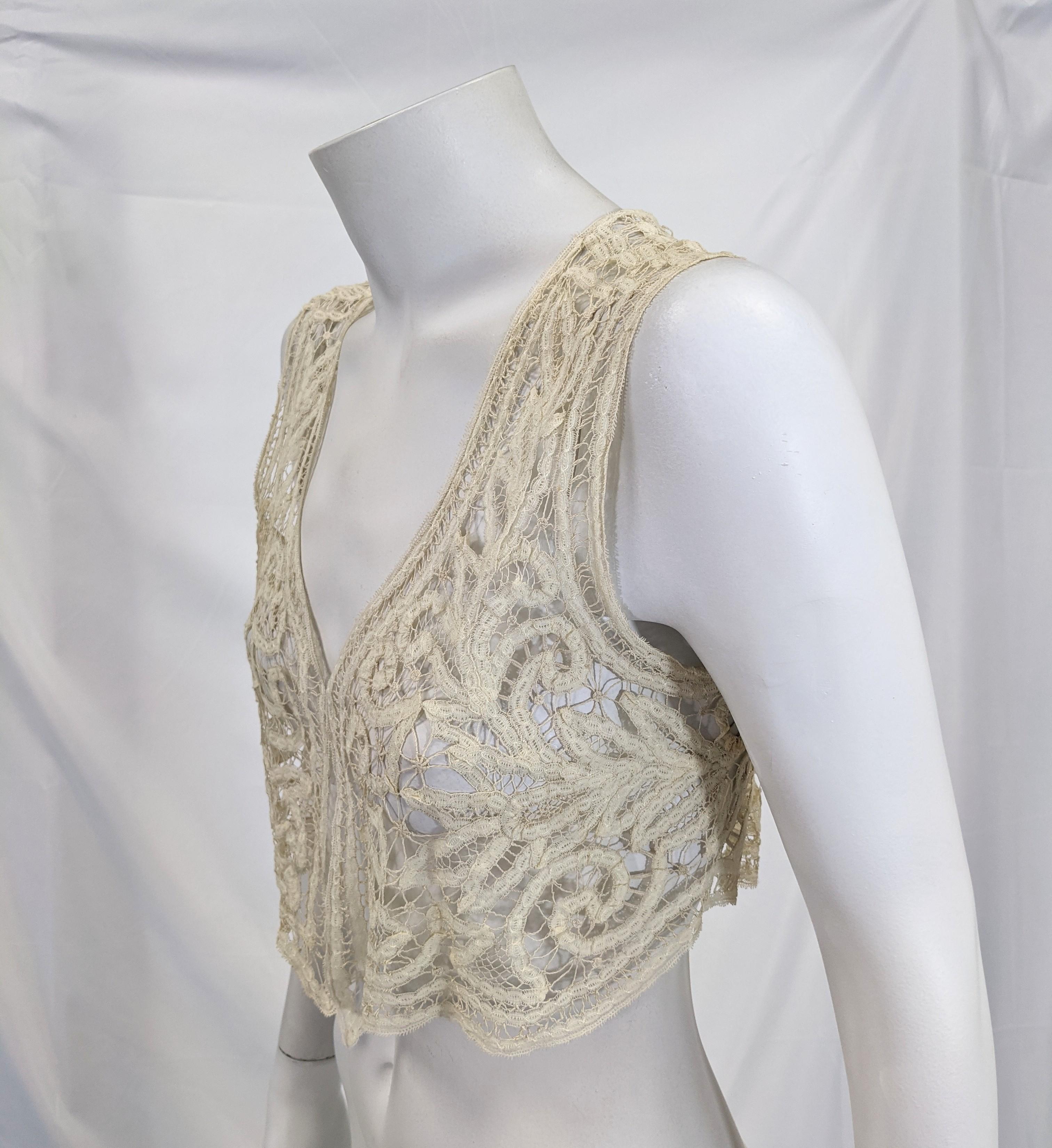 Lovely Edwardian fine ivory cotton handmade tape lace vest with an elaborate leaf and floral motif .
Excellent Condition. Small size 0-2-4
bust 30