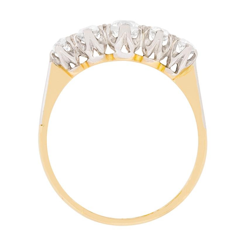 Dating back to the Edwardian era, this ring features old cut diamonds graduating in size. The centre diamond, claw set, weighs 0.40 carat, the two either side 0.25 carat each and the outer dazzling diamonds, 0.15 carat each. This brings the total to