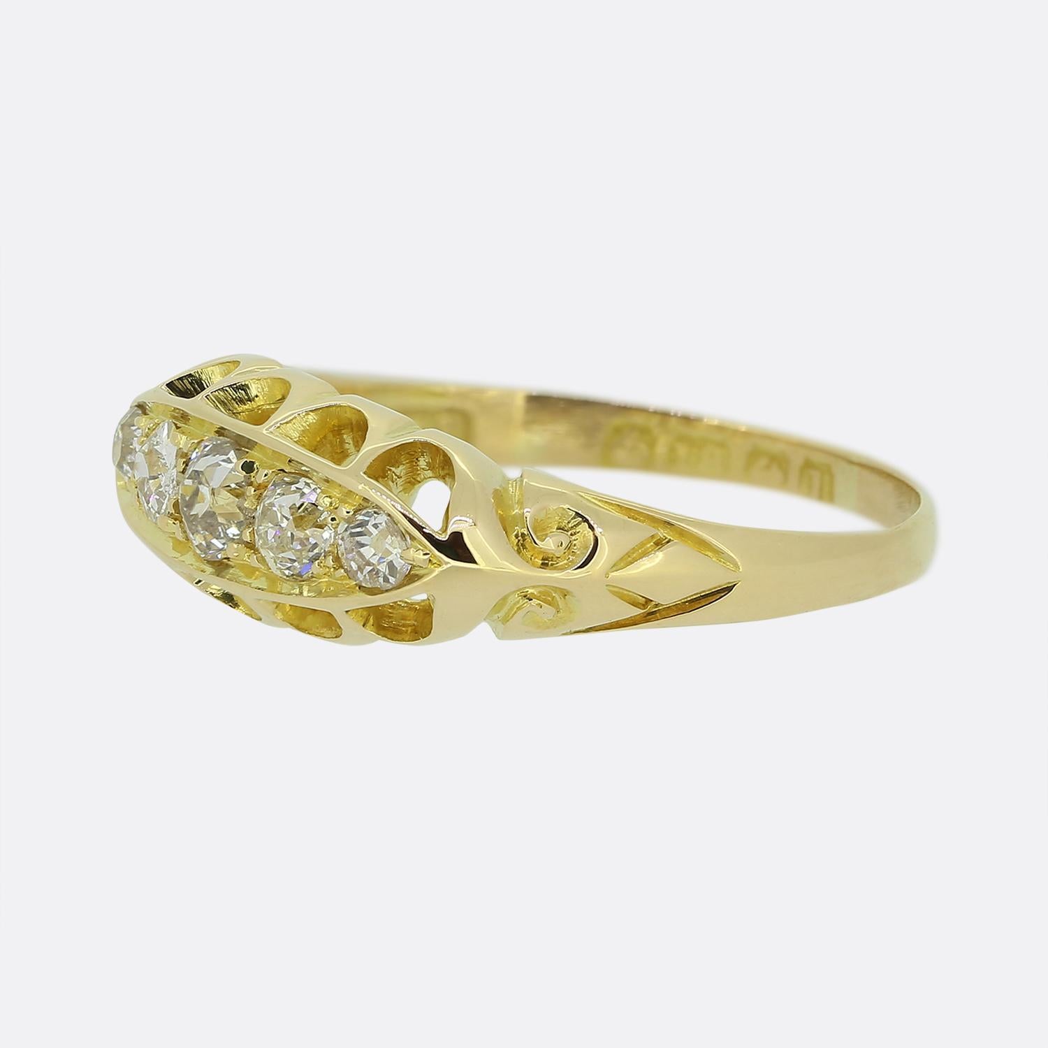 Here we have an lovely Edwardian five-stone diamond ring. This piece has been crafted from 18ct yellow gold and features five round faceted old cut diamonds which graduate in size towards the centre in a single line formation. The ring also