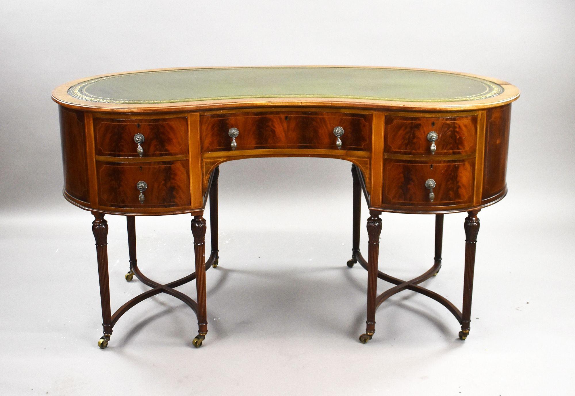 Edwardian Flame Mahogany Kidney-Shaped Writing Table
Item Code: 1386
A striking early 20th-century Edwardian kidney-shaped writing table, crafted in richly figured flame mahogany and standing gracefully on eight finely carved, reeded legs united by