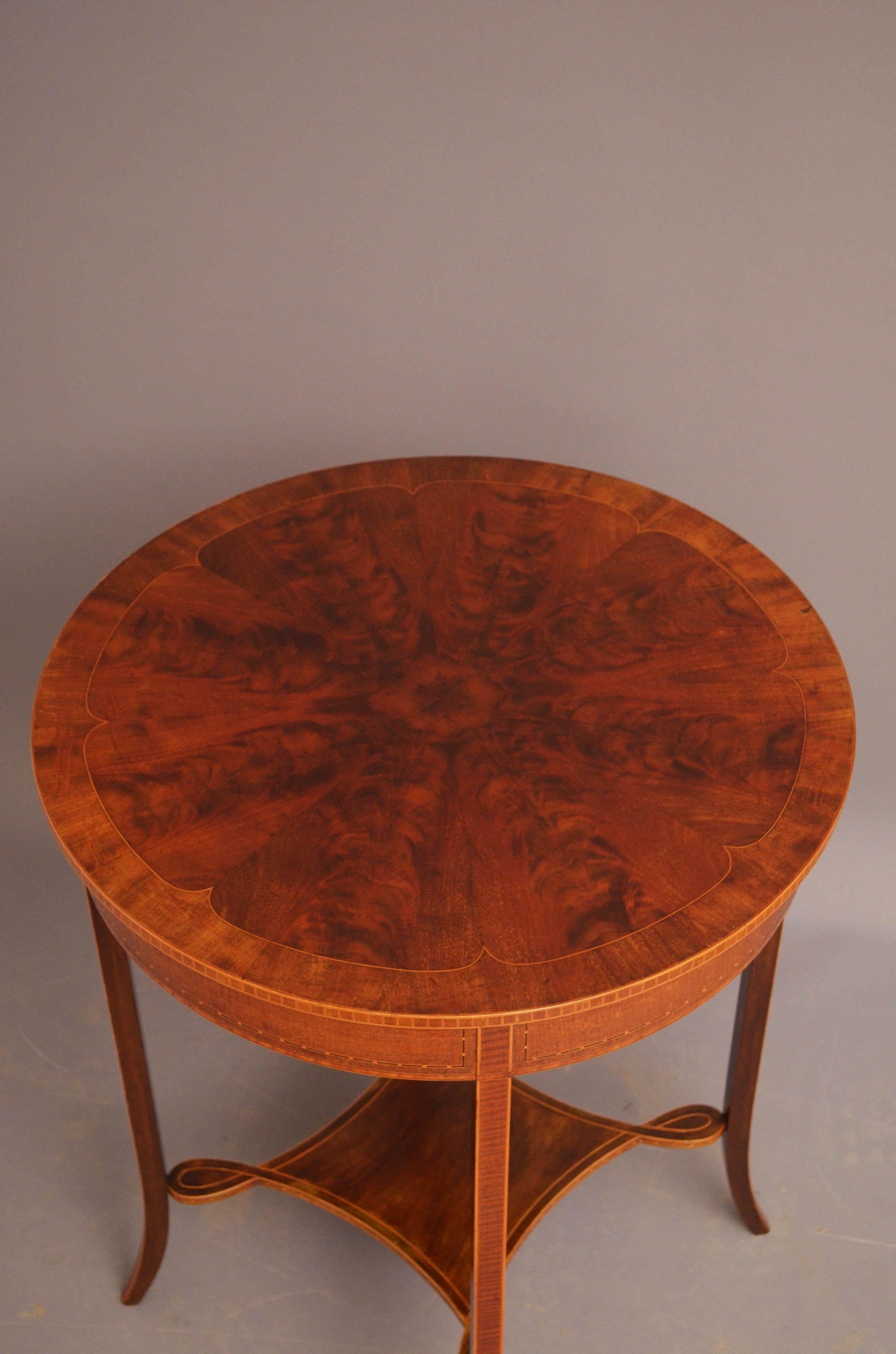 St07 Fine quality Edwardian occasional table in mahogany, having stunning segmented, flamed mahogany top with satinwood stringing, mahogany banding and inlaid edge above inlaid frieze and four outswept inlaid legs united by shaped and inlaid