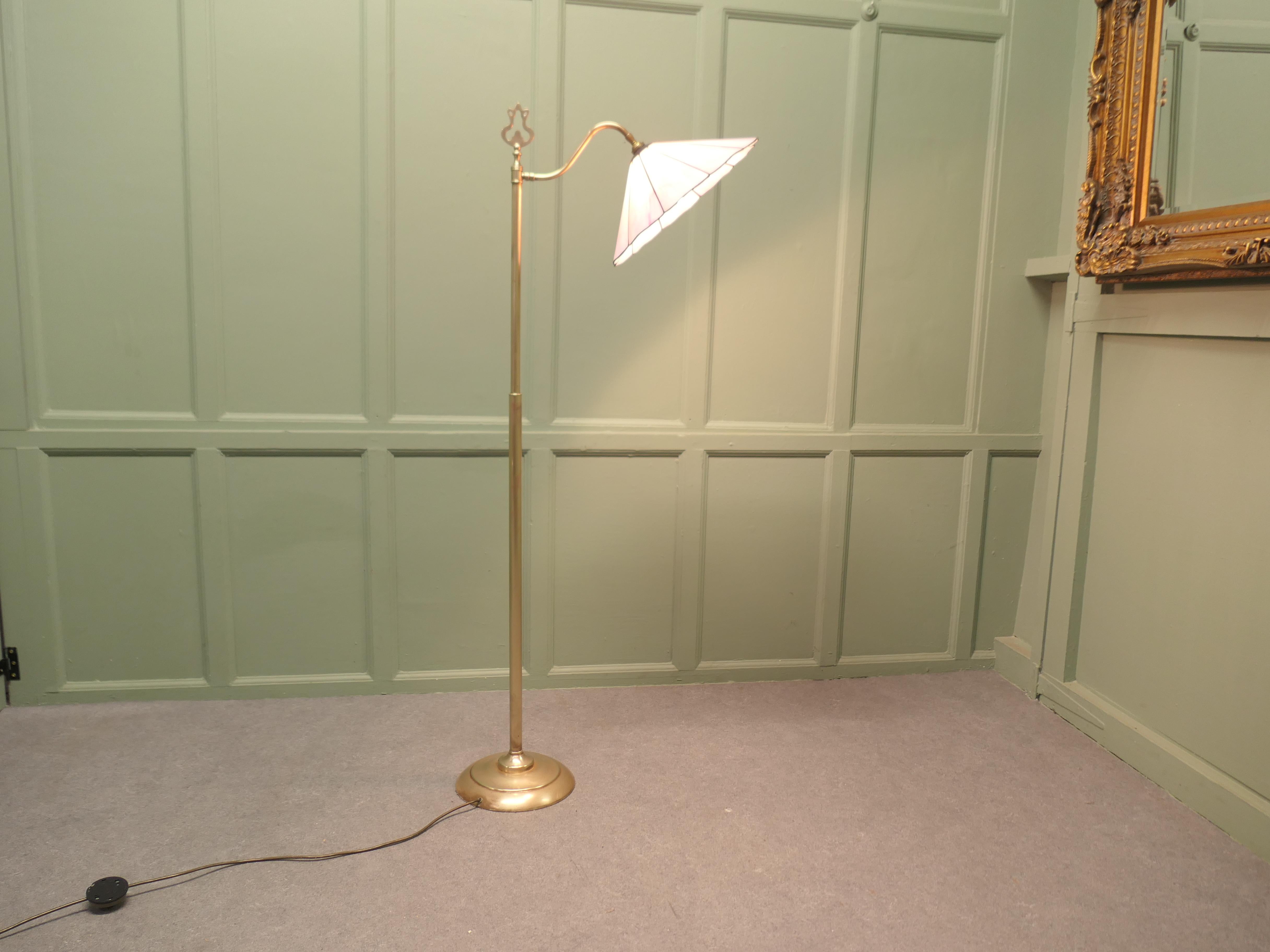Edwardian Floor Standing, Swivel, Angle Reading Lamp

This charming floor Standing reading lamp, can be angled and swivelled for best advantage
The lamp is made in brass, it has a pink glass petal shaped lampshade
It is in good and working