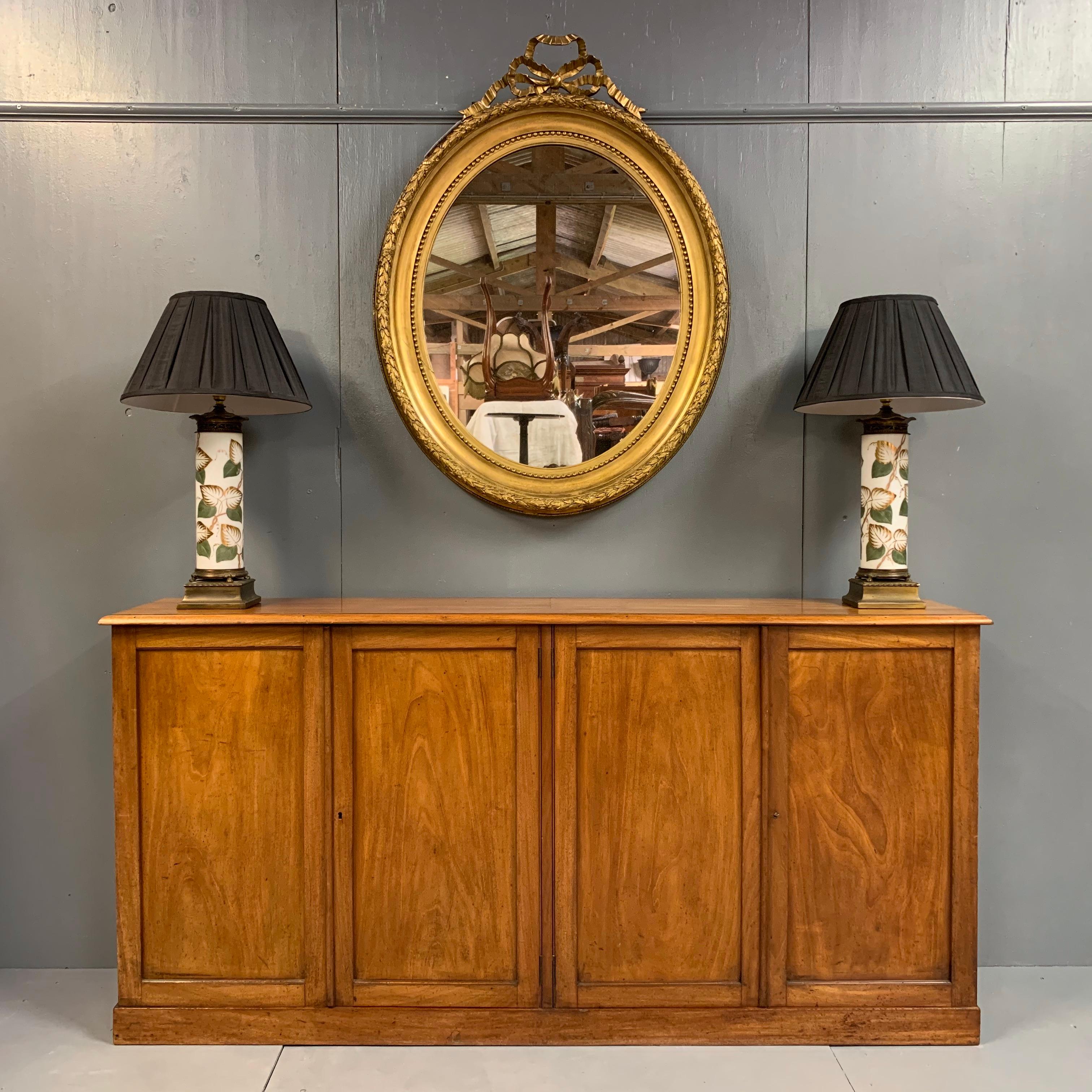 Lovely size Edwardian four door paneled low bookcase or credenza sideboard with simple paneled doors and in a pale mahogany, well cleaned and beeswax polished.
Internally, there are three shelves which are supported by fitted batons, but you can
