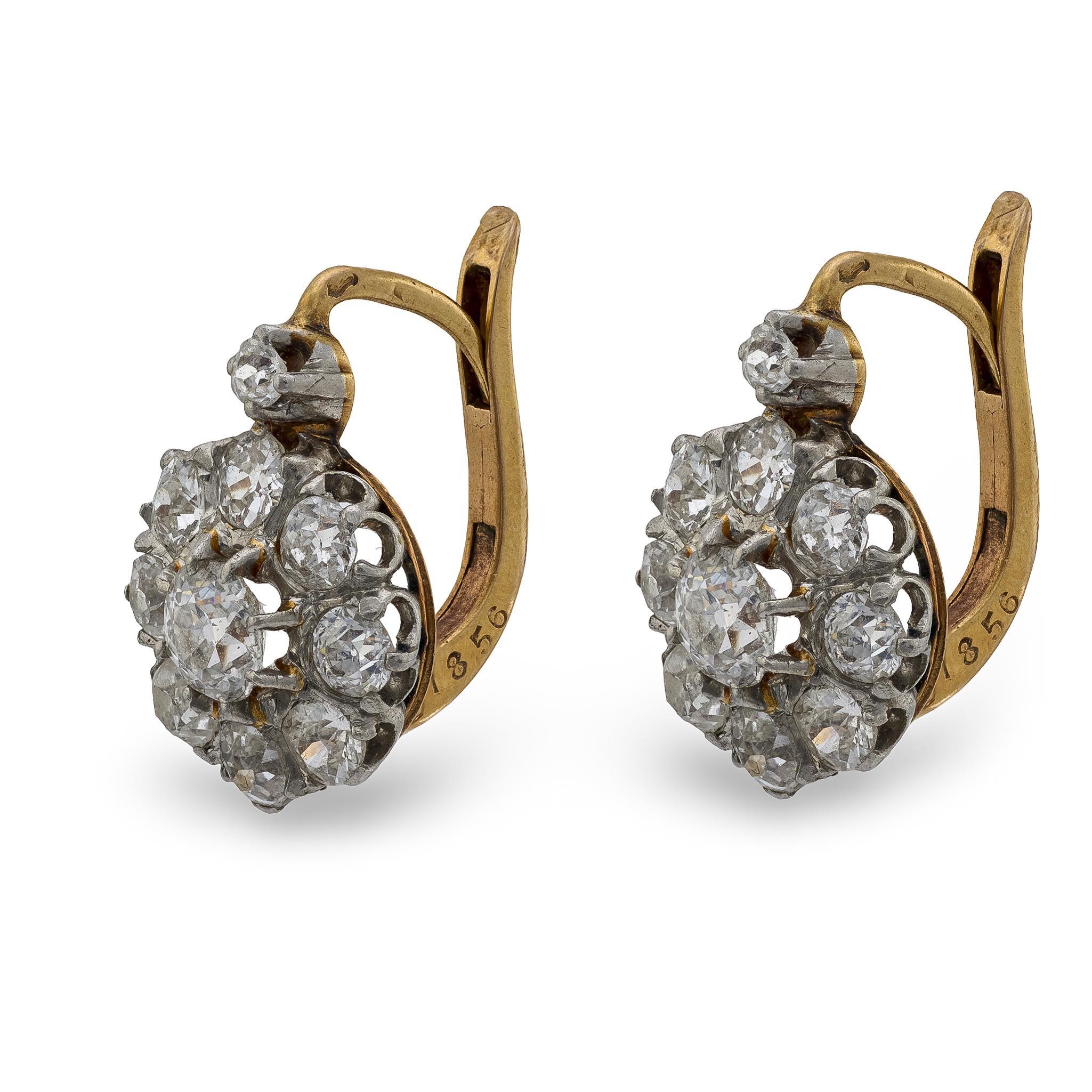 An incredible pair of diamond earrings from the Edwardian (ca1910s) era! Crafted in 18k yellow gold and topped in platinum, these earrings feature 2.50ctw of old mine cut diamonds, which are all prong-set. The diamonds are organized to represent a