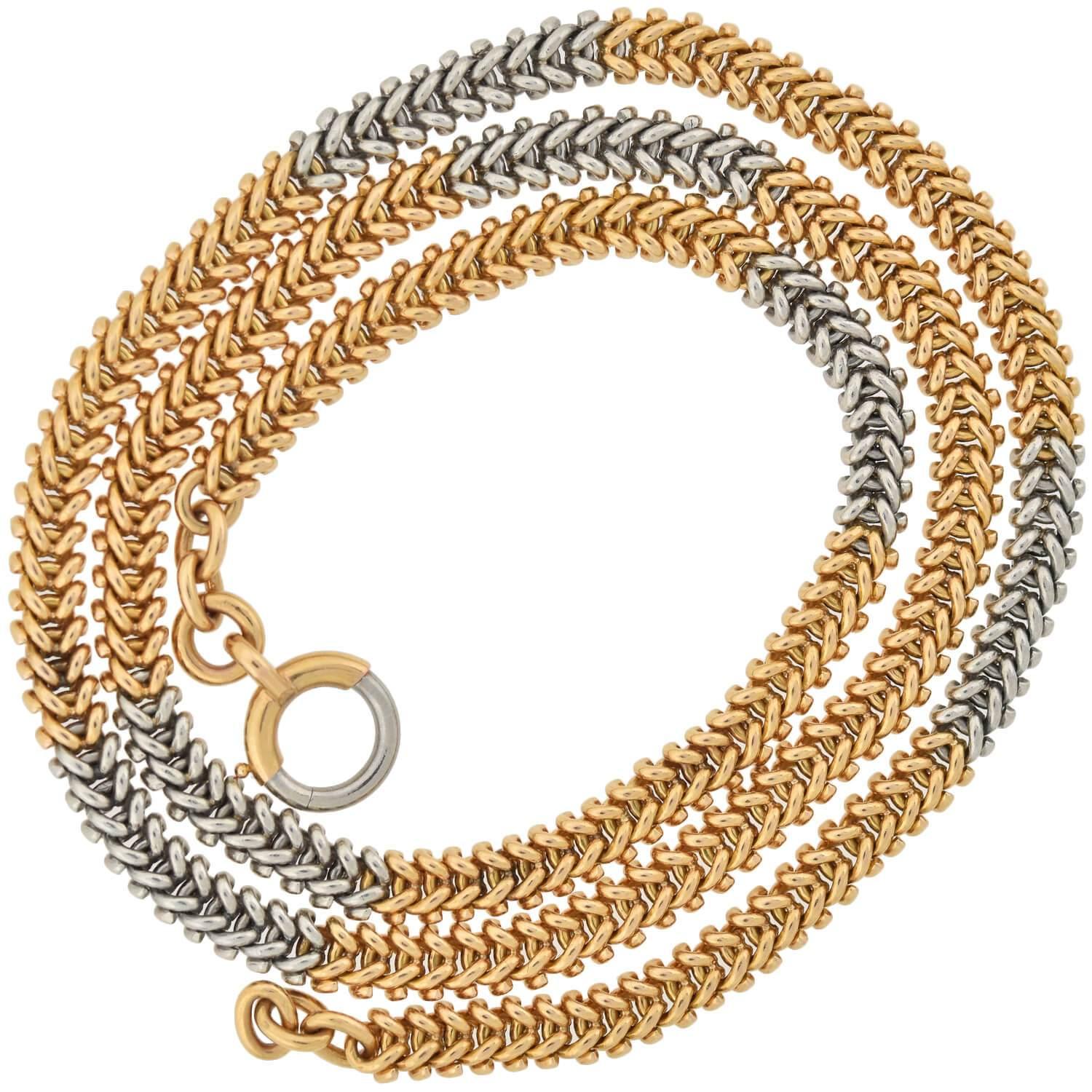 An exquisite French-made mixed metals chain from the Edwardian (ca1910s) era! This beautiful, weighty piece features a pattern of 18kt rose gold chain that alternates with sections of gleaming platinum links to create a wonderful two-tone appeal.