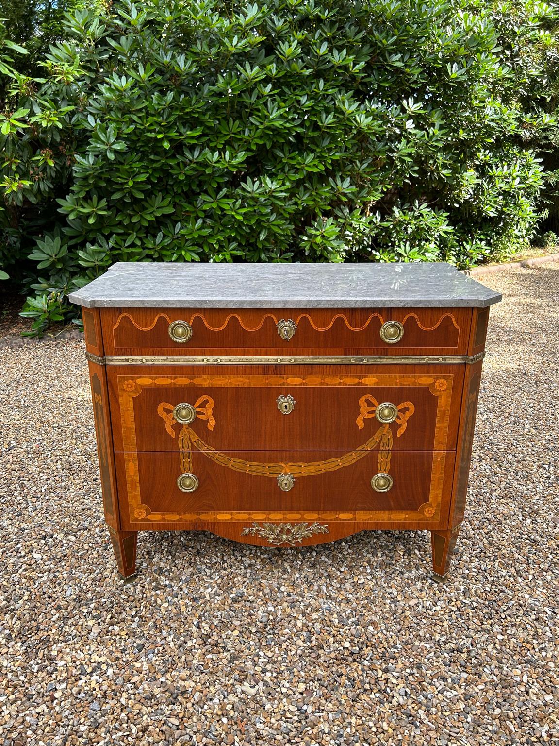 A super quality Edwardian French Commode / Chest of Drawers with beautiful inlay of various woods throughout. A solid removable Marble top, three drawers and original french brass fittings and handles. The inlay work is amazing with floral