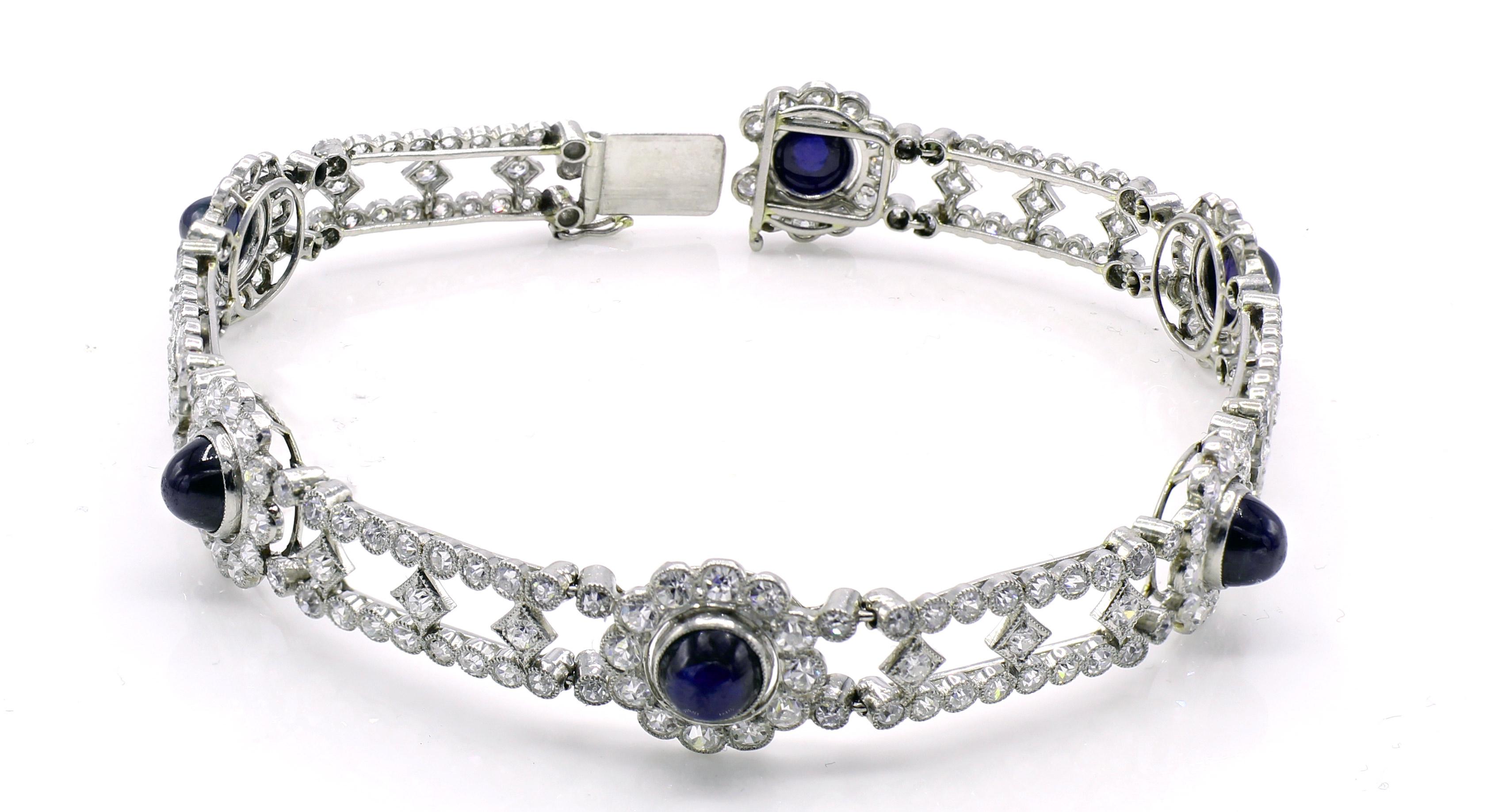 Beautifully designed and magnificently handcrafted Edwardian bracelet from ca 1910. Bezel set with bright white diamonds and detailed with milligrain on top of the bezel, the flexible sections have 5 beautiful sugar loaf cabochon sapphires