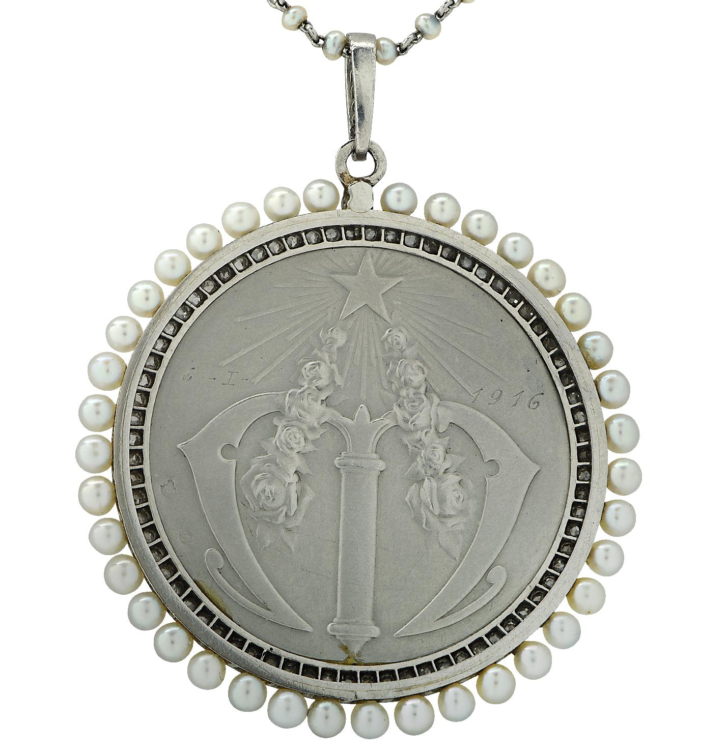 Beautiful Edwardian Art Nouveau Frederic Vernon Seed Pearl Pendant, circa 1900's, crafted in platinum, featuring an image of a Virgin carved in mother of pearl, detailed with seed pearls and 80 rose cut diamonds. The back of the pendant is engraved