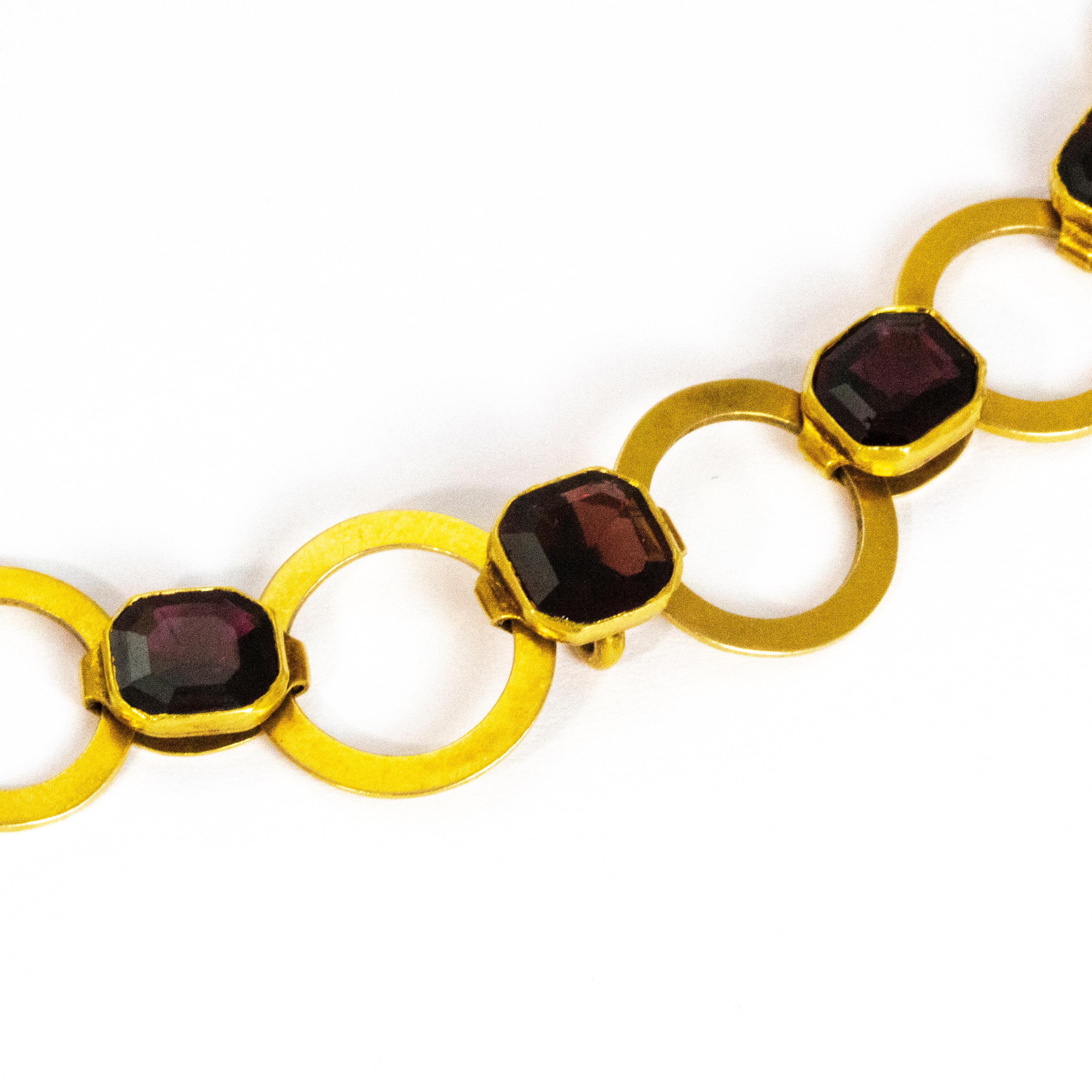 In between every smooth gold loop in this chain sits a bright sparkling garnet. The necklace sits beautifully flat against the neck and also, as a little added bonus, has a tiny hook on the back of the centre garnet from which you can hang a pendant