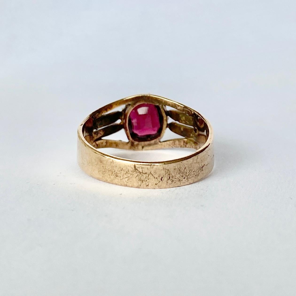 Set within this glossy 9ct gold ring is a gorgeous deep red garnet. The gold has a very soft rose gold feel to it and has some gorgeous engraving. Made in 1907 Birmingham, England. 

Ring Size: Q 1/2 or 8 1/4 
Stone Dimensions: 8.5x7mm 

Weight: 3.1g