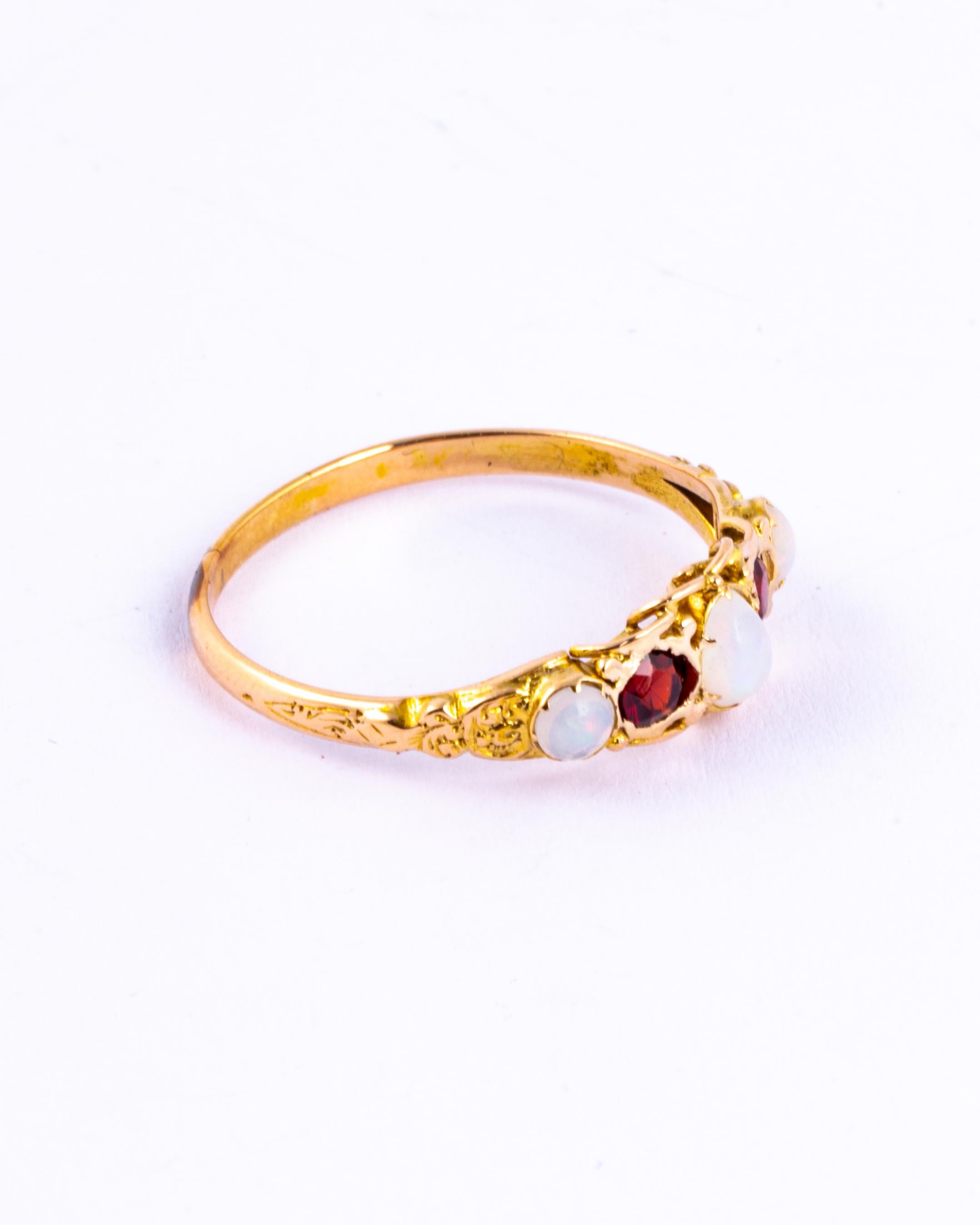 Either side of the glittering garnets in this ring are gorgeous and colourful opals. The garnets total 30pts and the opals total approx 45pts. The setting and shoulders of this ring are so decorative and modelled in 9carat gold. 

Ring Size: T or 9