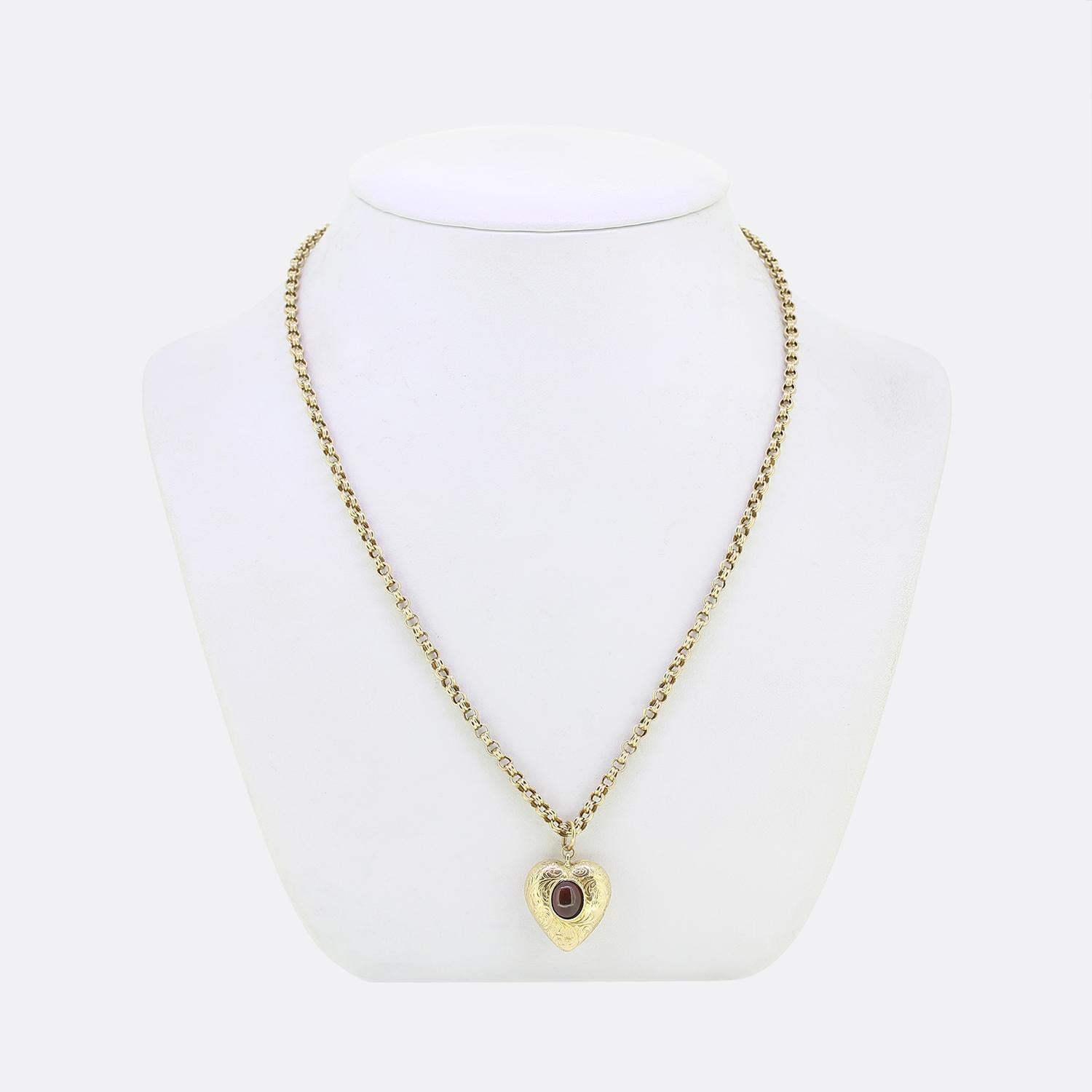 Here we have a delightful ruby pendant necklace. This antique pendant has been crafted from 9ct yellow gold into the the shape of a love heart. This hollow motif has then been meticulously engraved with a fauna and flora design whilst being set at