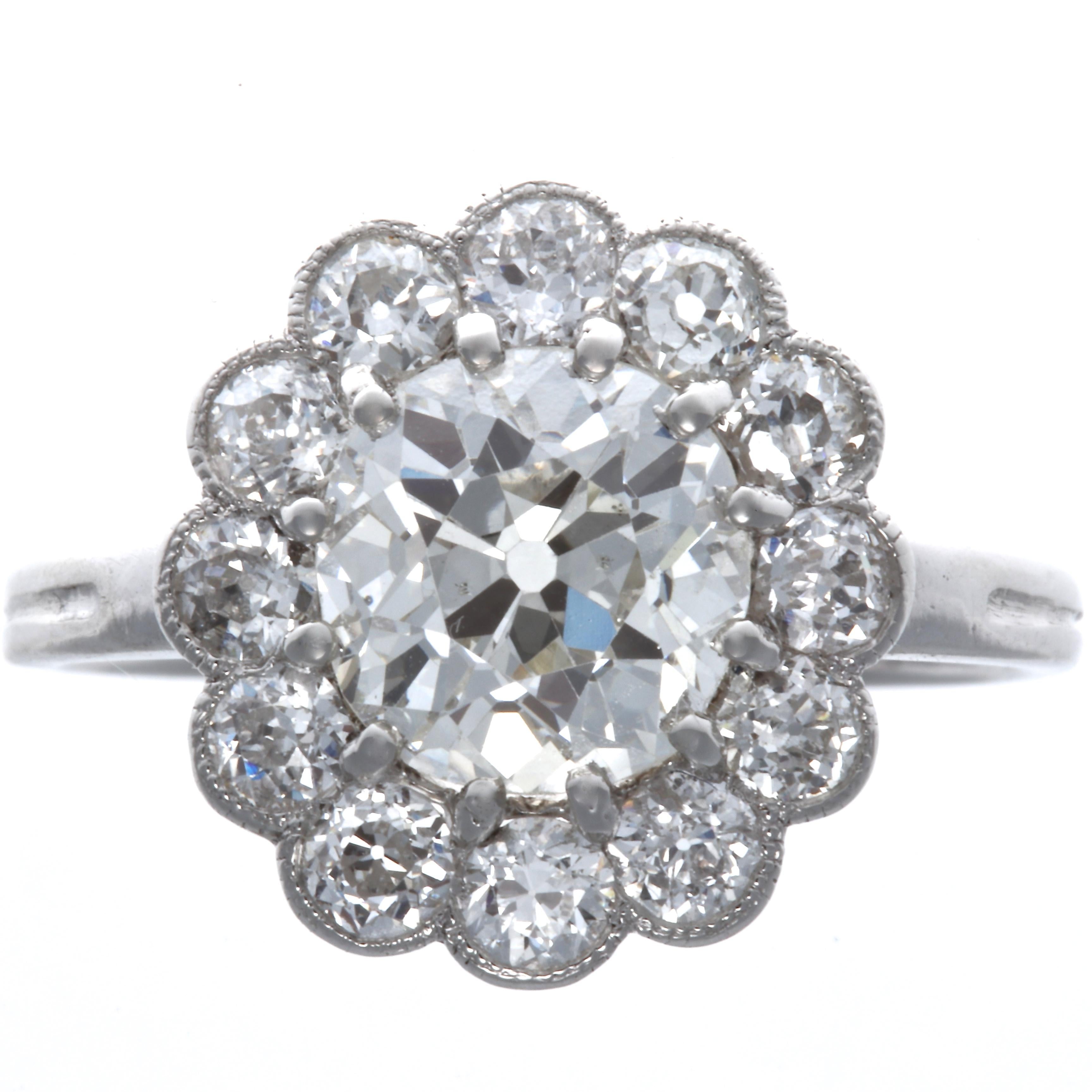 From a time long ago and a place far away comes this fragrant flower, still as fresh as todays bouquet. The Old European cut 1.73 carat is GIA certified as J color SI1 clarity. Accented by 2 Old European cut  diamonds weighing approximately 0.75