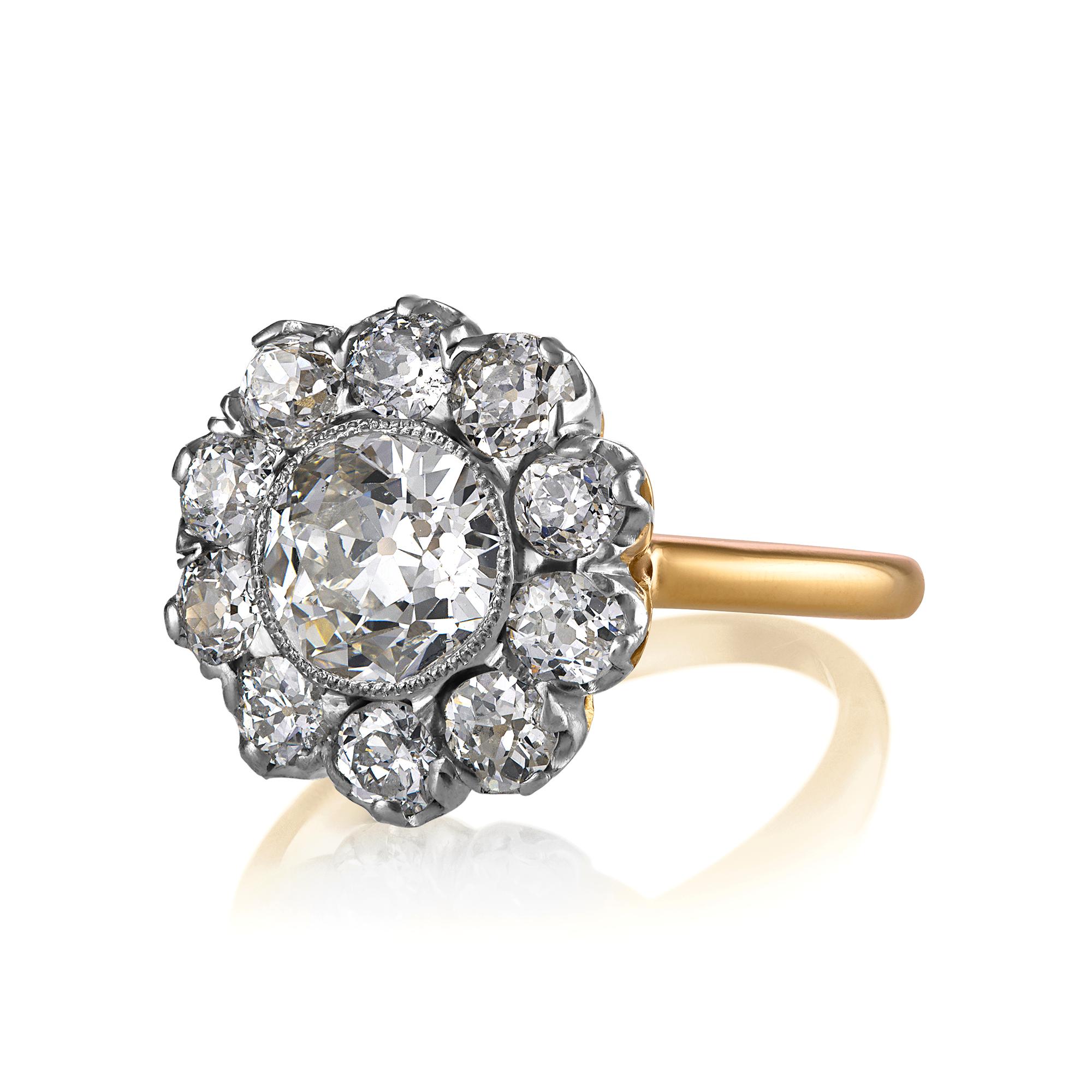 This breathtakingly beautiful, darling, early-twentieth century Edwardian Flower shaped, Cluster Ring finely hand crafted in platinum over 18 karat yellow gold.

The Center Diamond is an OLD EUROPEAN Cut 1.57ct in J color, SI1 clarity, accompanied