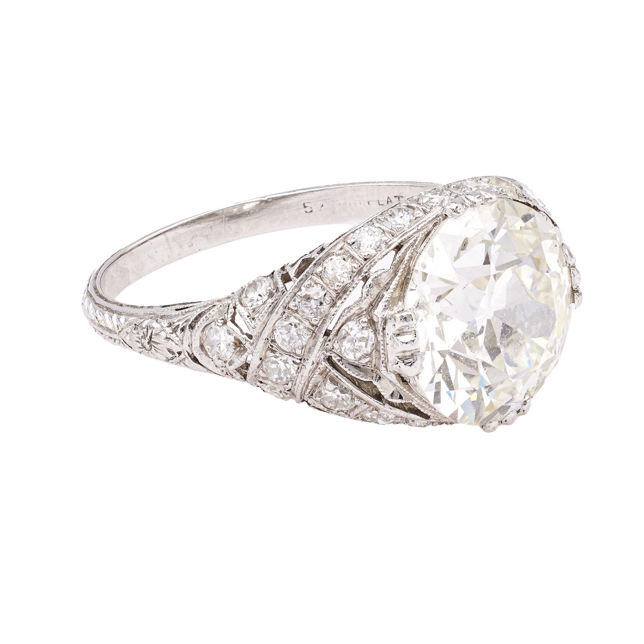 One Edwardian GIA 4.14 Carat Old European Cut Diamond Platinum Filigree Ring. Featuring one GIA old European cut diamond of 4.14 carats, accompanied with GIA #2211123041 stating the diamond is J color, SI2 clarity. Accented by 28 old European cut