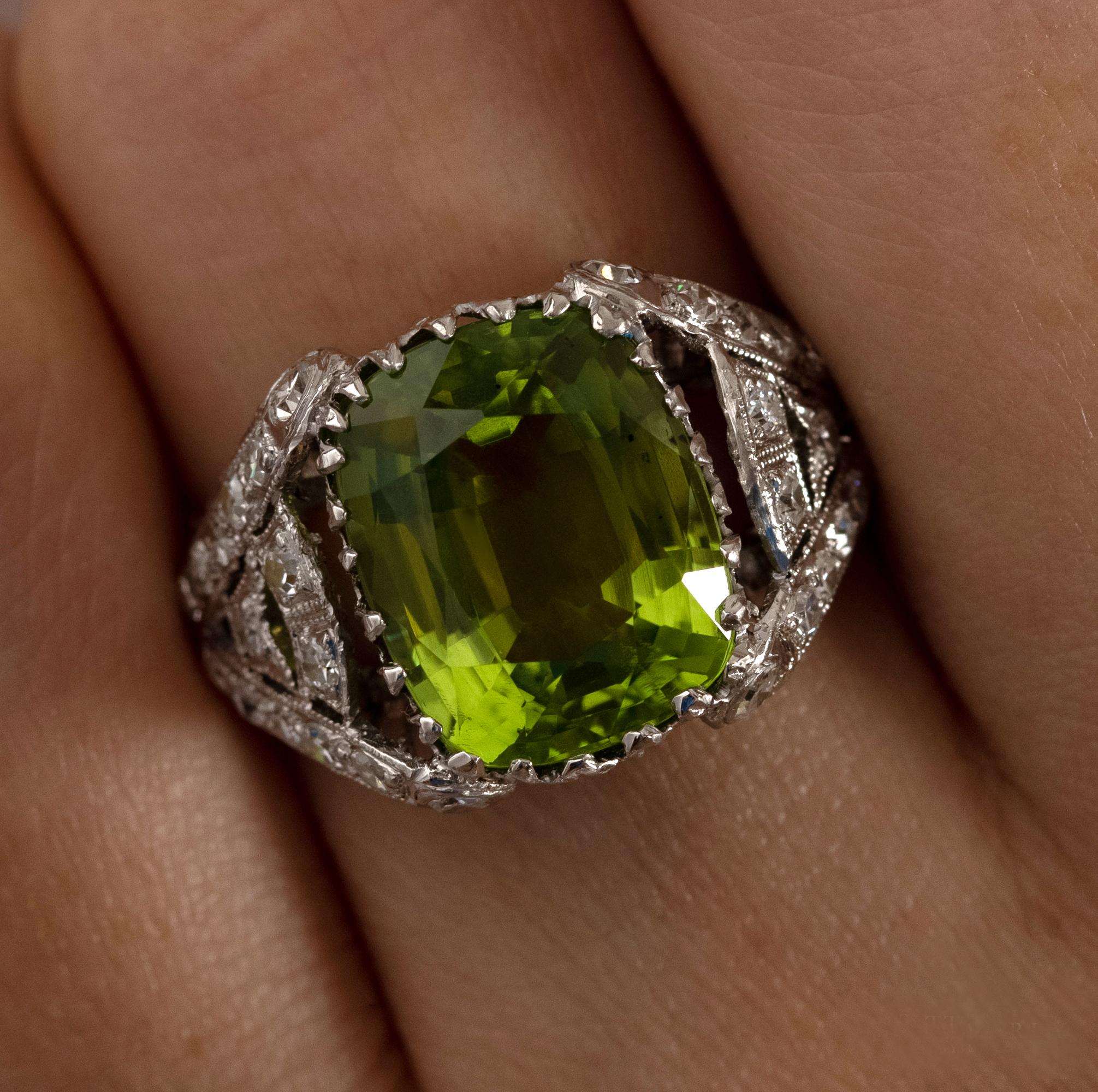 Antique GIA 6.73ct Old Cushion Peridot and Diamond Edwardian Platinum Ring.
From the mid-1800s, Peridot was a favored stone in jewelry, reaching the height of its popularity during the aesthetic period of the Victorian era and the reign of Edward
