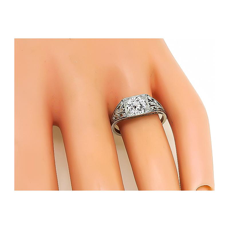This is a stunning platinum engagement ring from the Edwardian era. The ring is centered with a sparkling GIA certified old European cut diamond that weighs 1.02ct. The color of the diamond is I with VS1 clarity. The top of the ring measures 7mm by