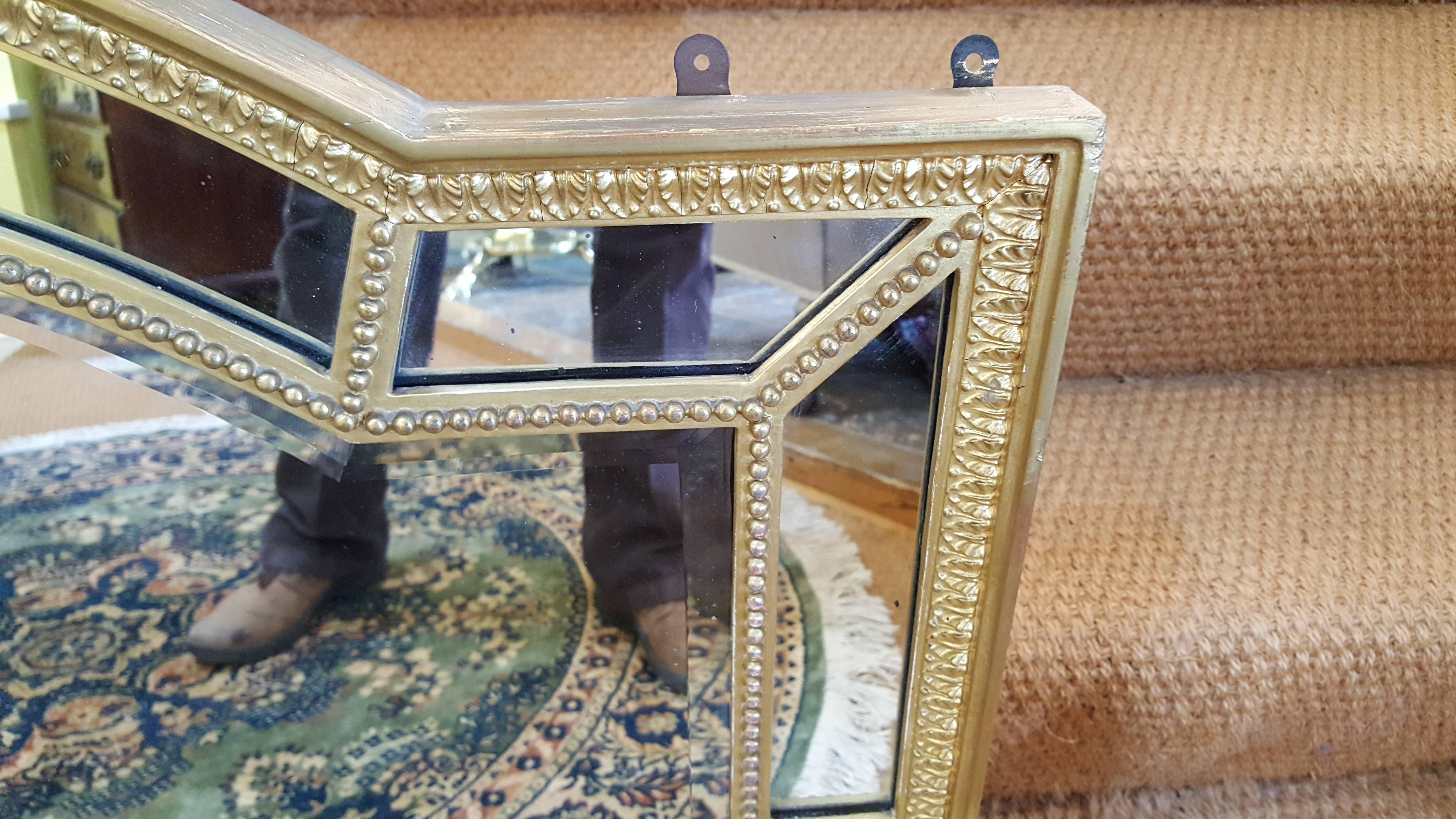 Edwardian giltwood mirror with double bevelled domed central plate framed by ten sectional mirrors
Measures: 41 1/2