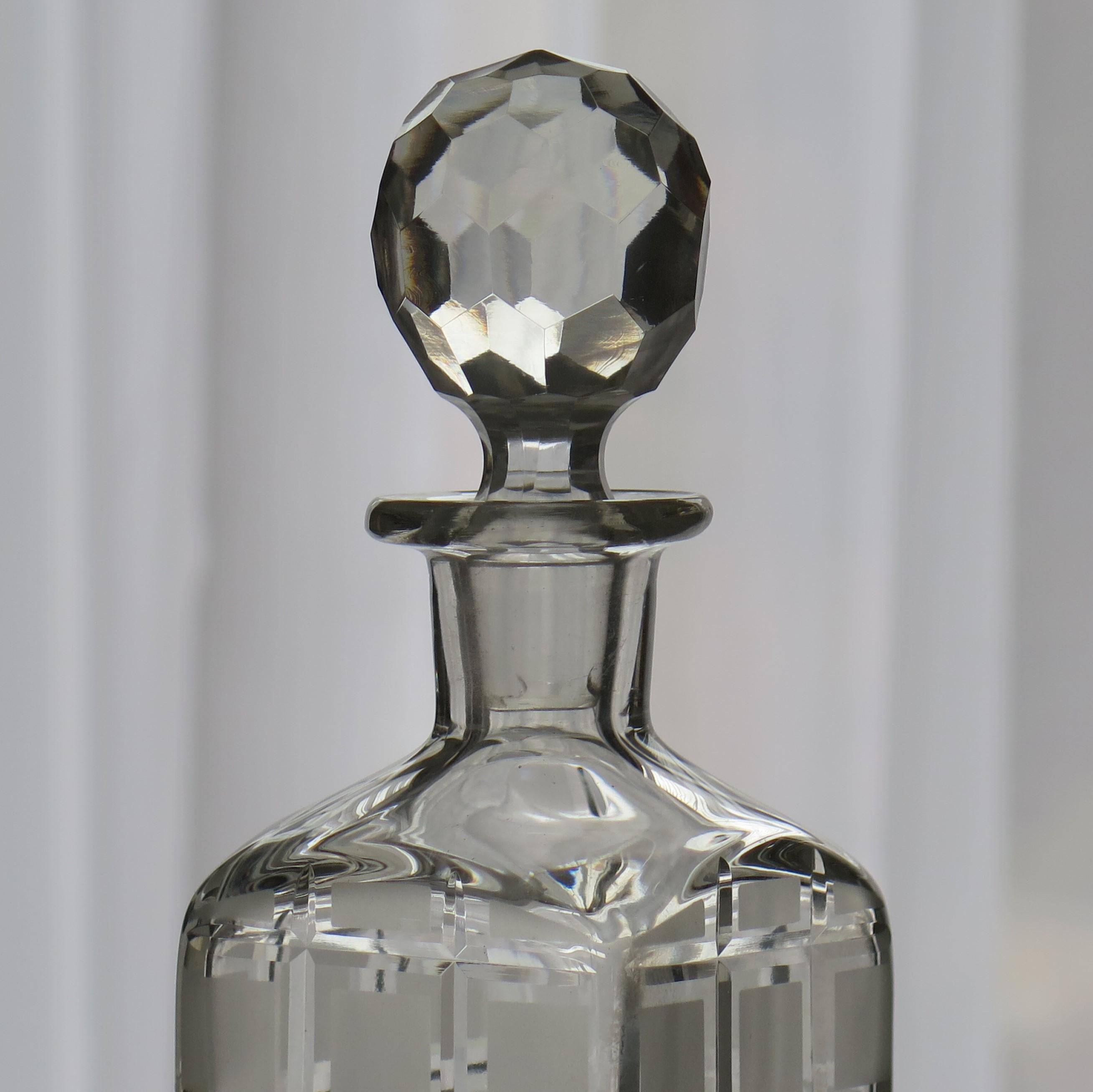This is a good cut-glass crystal decanter or wine carafe, with a square shape having cut and etched decorative squares decoration and with a cut glass stopper, made of heavy lead glass, and dating to Edwardian England, circa 1900.

This decanter