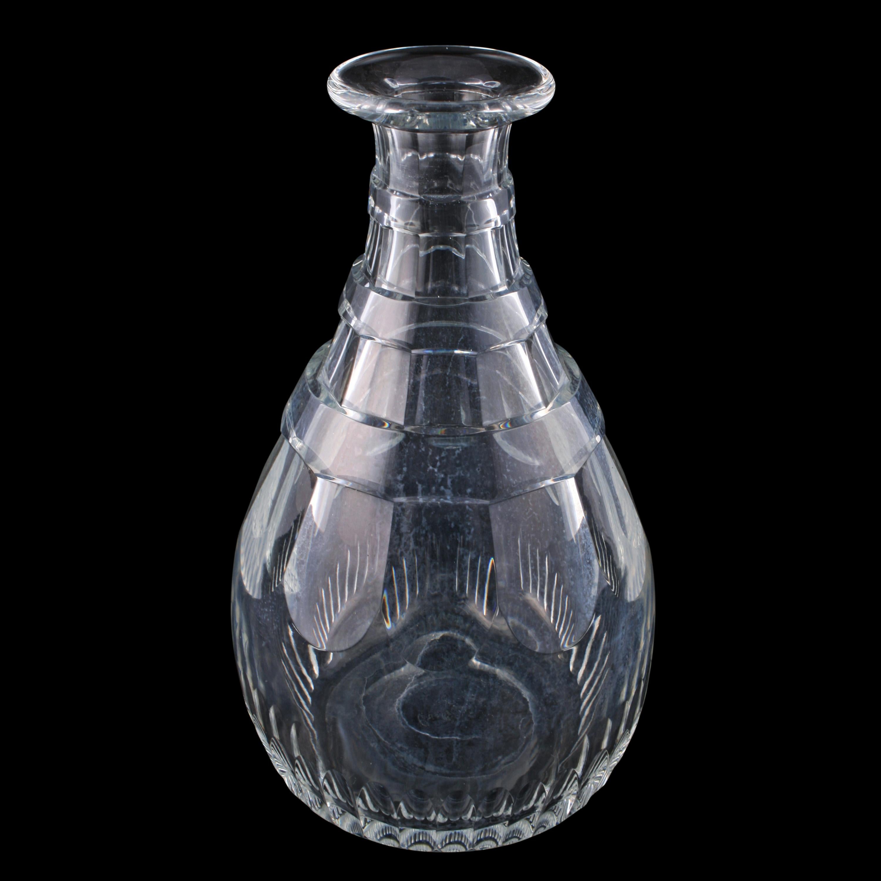 An early 20th century Edwardian magnum decanter.

The decanter is facet cut with a triple ring neck, a lozenge shaped stopper and a ground pontil mark.

The decanter is in good condition with some wear to the base as expected, circa