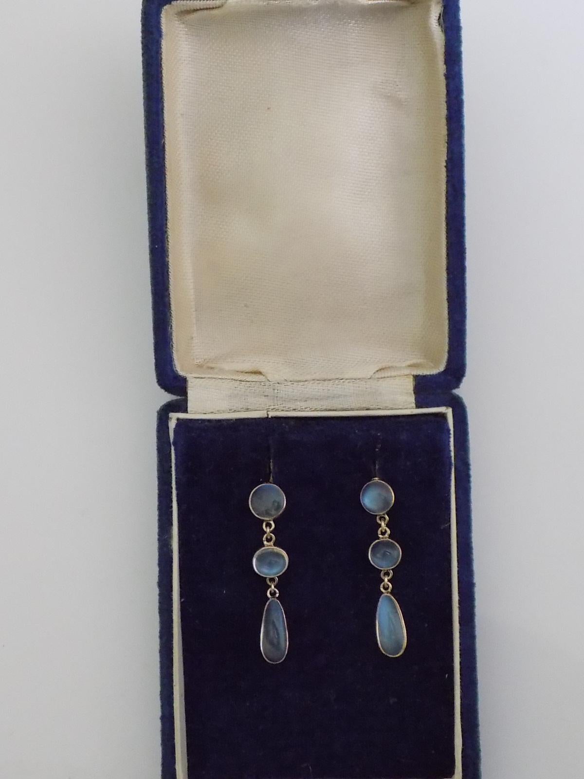 A Gorgeous Edwardian c.1900 9 Carat Gold and Moonstone drop earrings for pierced ears in antique box as found.

Drop 31mm.
Width of the top Moonstone 7mm.

The earrings in excellent condition for the age and ready to wear.