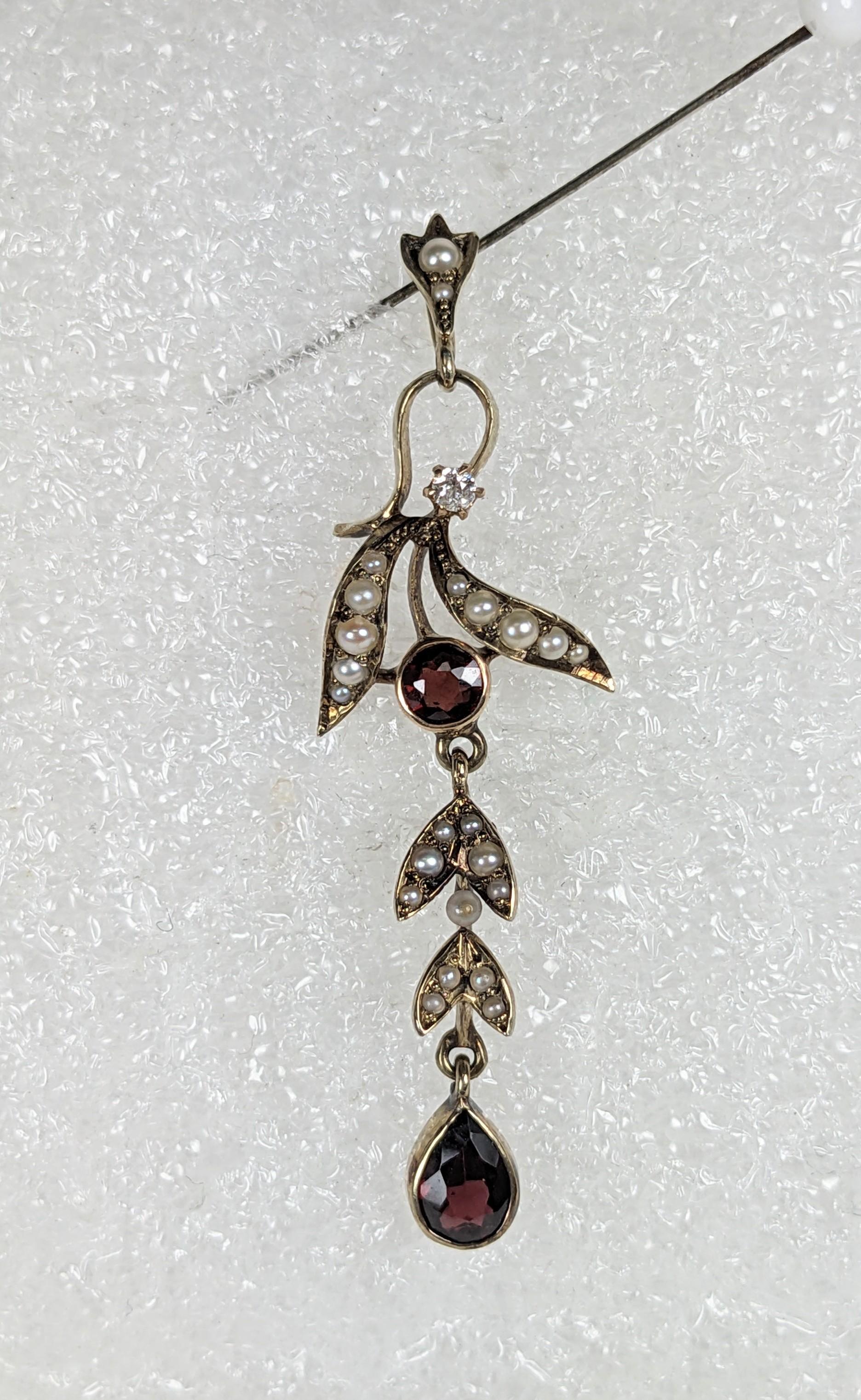 Edwardian 18k Gold Diamond and Garnet Pendant from the 1880's. Designed as an articulated vine with seed pearl leaves, garnet and a small diamond accent. 2