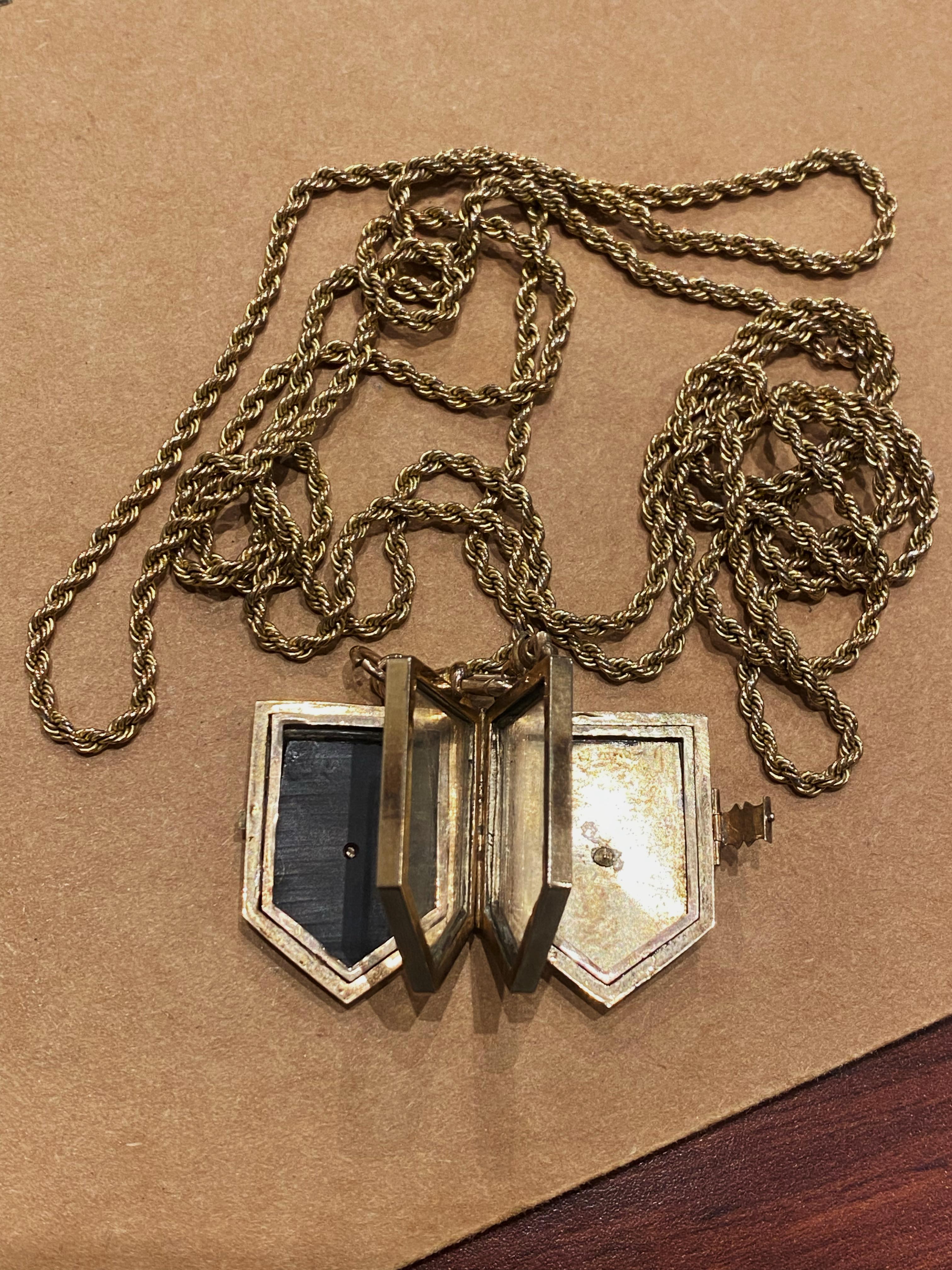 This intricate one-of-a-kind antique piece 
comprises a locket & a guard chain, 
coming from the same – Edwardian – period:

Fine & Rare (possibly unique) LOCKET, 
shaped as Shield, symbolizing protection against evils
opens up as a book to reveal