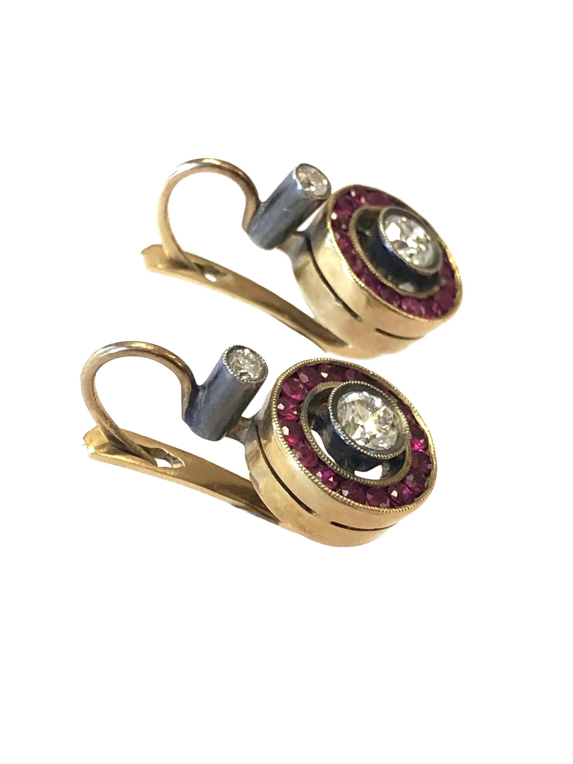 Circa 1915 - 1920 Yellow Gold with Silver Earrings, Measuring just under 1 inch in length and 1/2 inch wide, A European cut Diamonds set in a milgrain Bezel approximately .30 Carat and Surrounded by very Fine color Rubies with another Mine cut