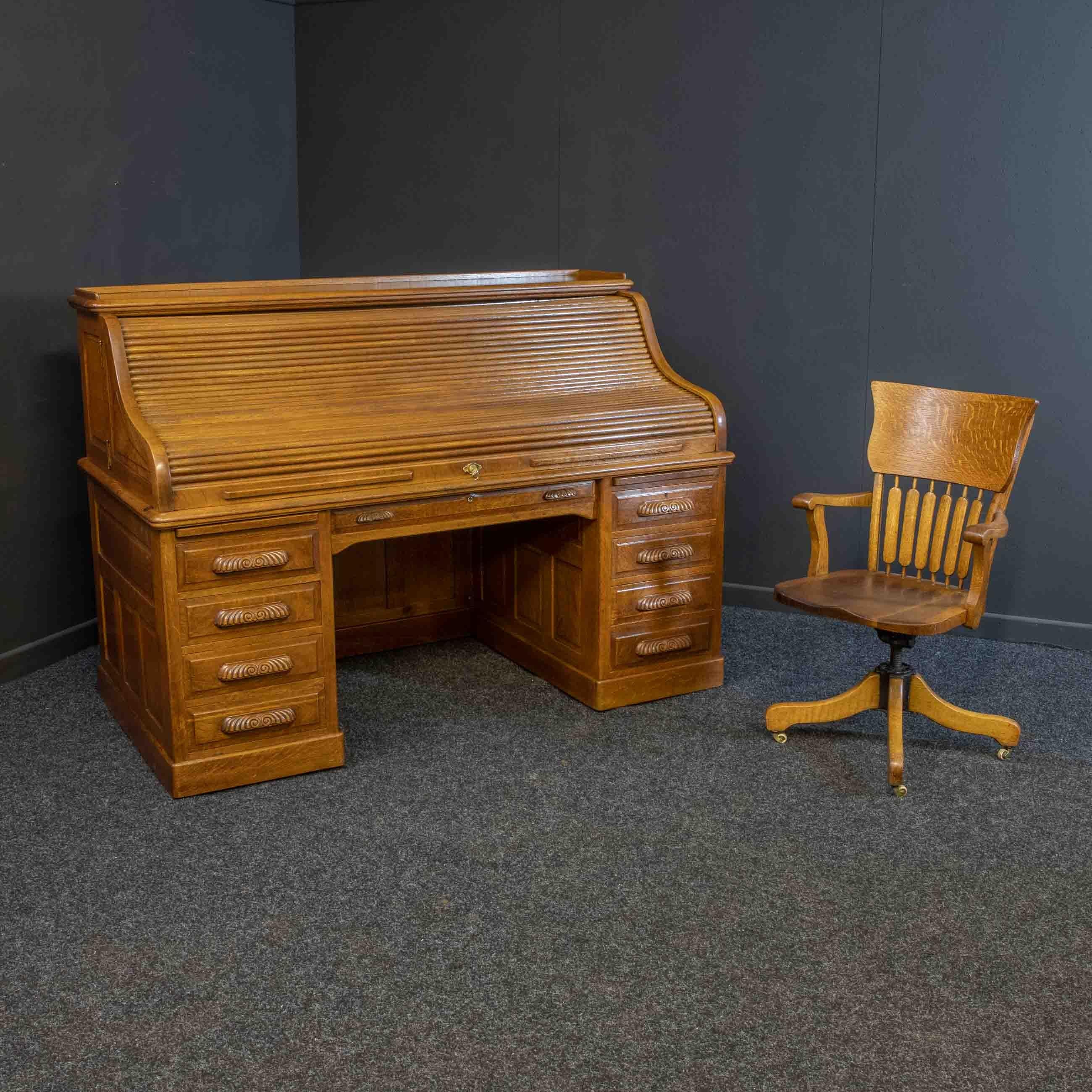 A truly magnificent golden oak roll top desk acquired from a stately home property in Scotland. Of exceptionally large proportions and absolutely top of the range in quality as you would expect of titled landed gentry. The fully fitted interior