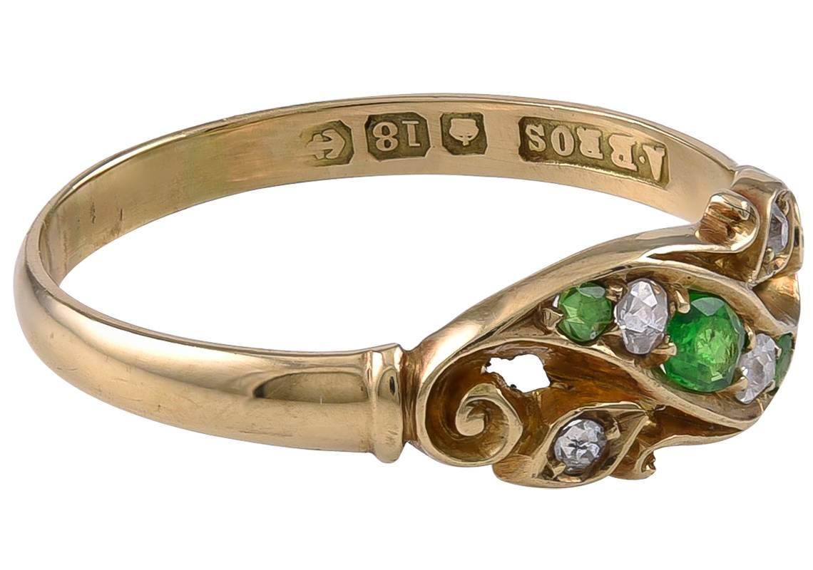 Of a lovely scrolling design and set with 3 Green (Demantoid) Garnets and 4 small Old European cut Diamonds. The inner shank hallmarked for 18k Gold, Birmingham anchor mark but date letter worn so I would guess the Ring was made around 1918.
This