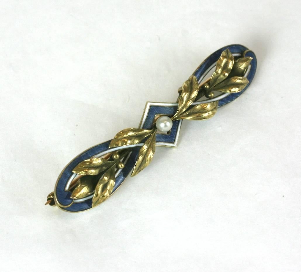 Exquisite Edwardian Green Gold and Enamel Brooch of wonderful quality. Taking cues from the decorative arts of the period, a wonderful a mix of French blue guilloche enamel, green gold  leaves and white enamel. 
Maker: Cresarrow, NJ. , Size 2.25