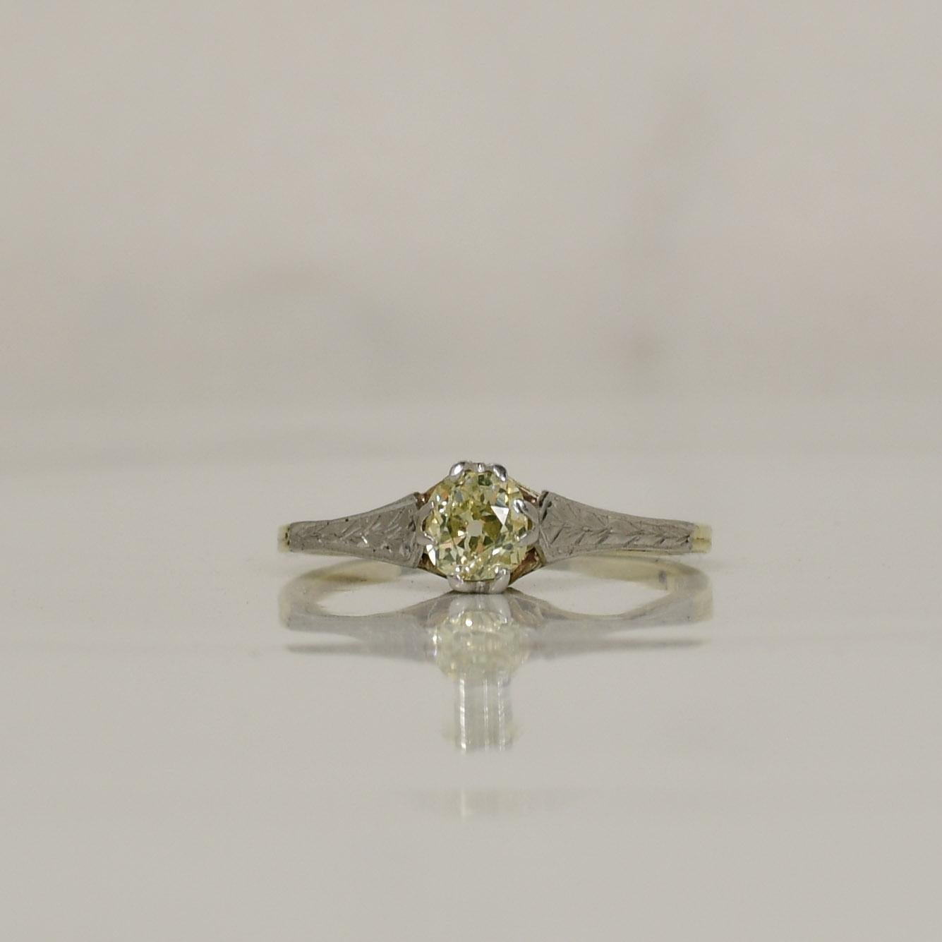 The Two Toned Gold Old Miner Cut 14K Yellow Diamond Solitaire Ring is a striking and distinctive piece of jewelry that seamlessly blends vintage charm with modern elegance. This exquisite ring showcases a brilliant old miner cut yellow diamond,
