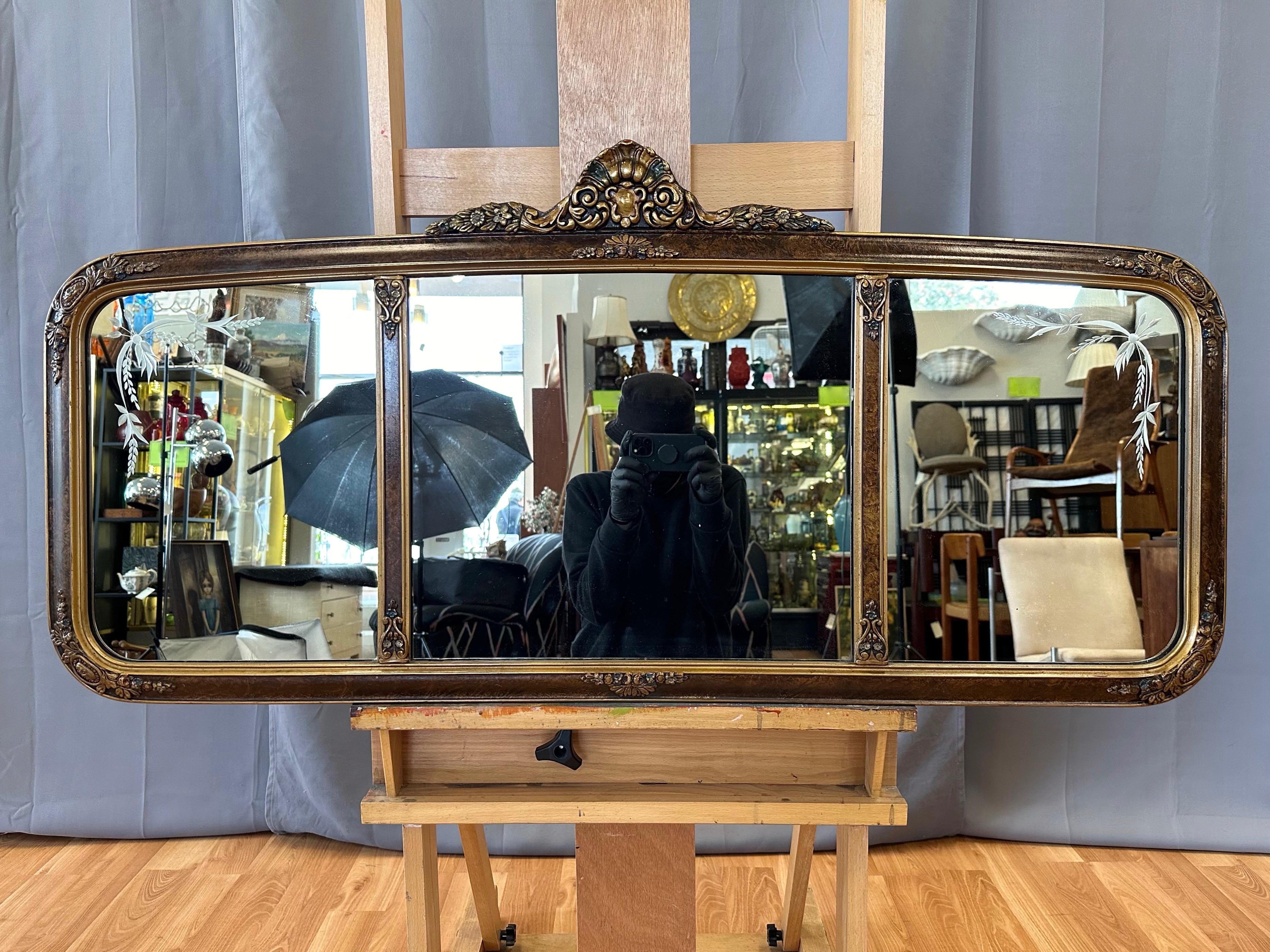 A brilliant circa 1910 Belle Époque-influenced Edwardian three-panel etched glass overmantel mirror with hand-crafted, hand-painted, and gilt-detailed frame.

Hand-crafted wide wood frame with hand-painted faux-leather finish and antiqued gilt trim.