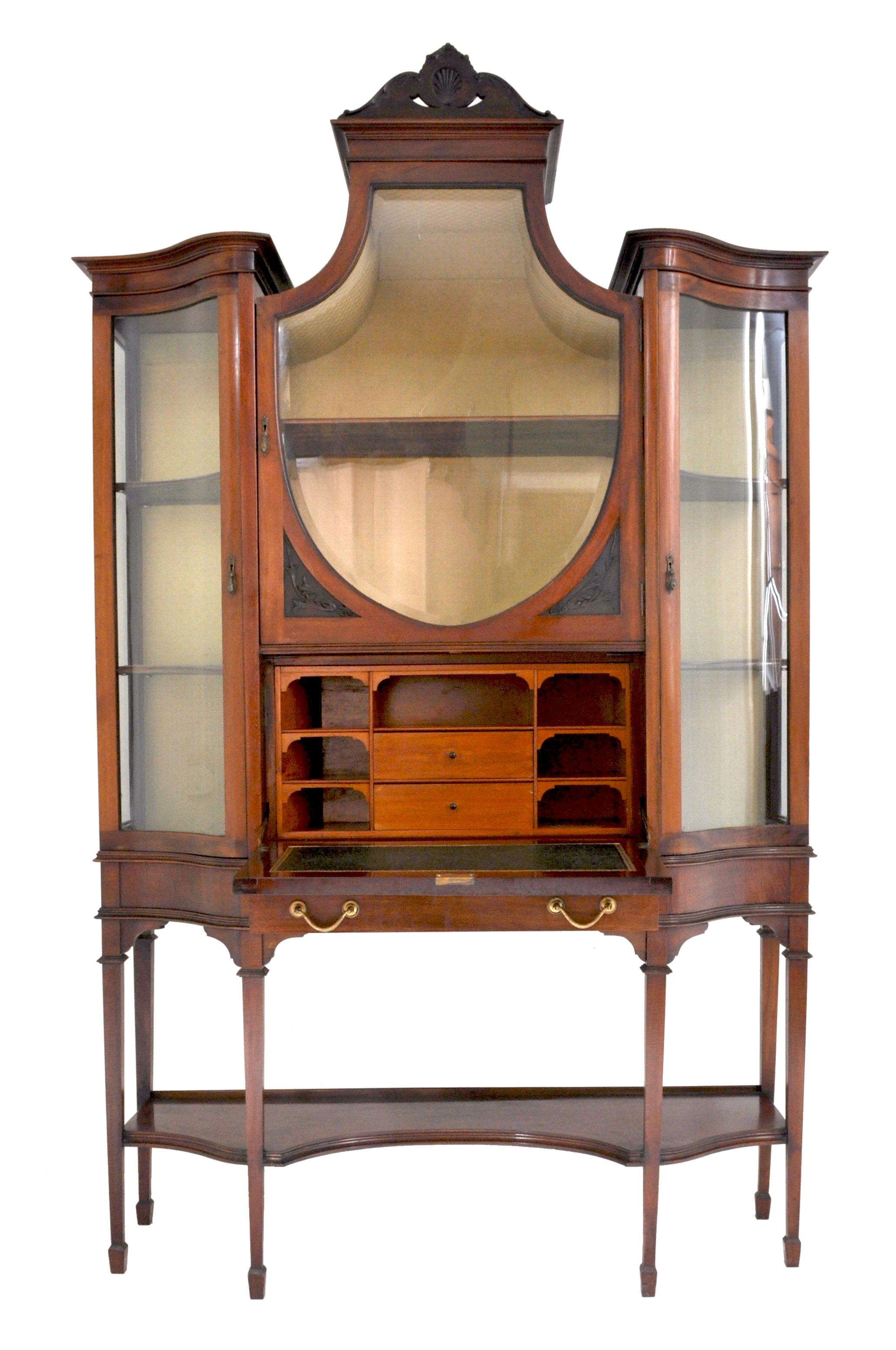 Antique Edwardian Hepplewhite Revival mahogany secretary desk/China cabinet/hutch, circa 1890. The cabinet having a carved crown with a shell molding, below is a shield-shaped beveled glass door, to each side are a pair of ogee-shaped glass doors