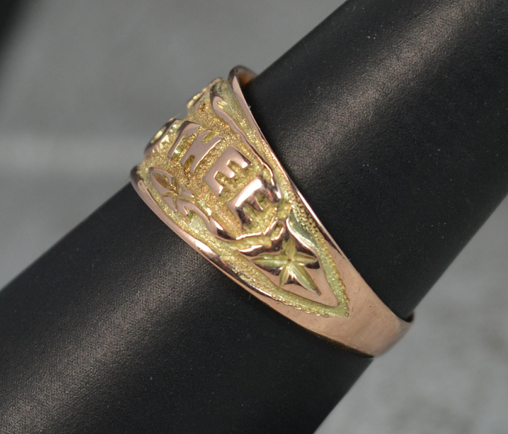 A superb Edwardian period band ring in solid 9 carat rose gold with hand engraved design.
​Designed with the phrase 'I Cling To Thee'. The statement is rendered in bold capital block letters with a smooth surface against a backdrop of textured gold.