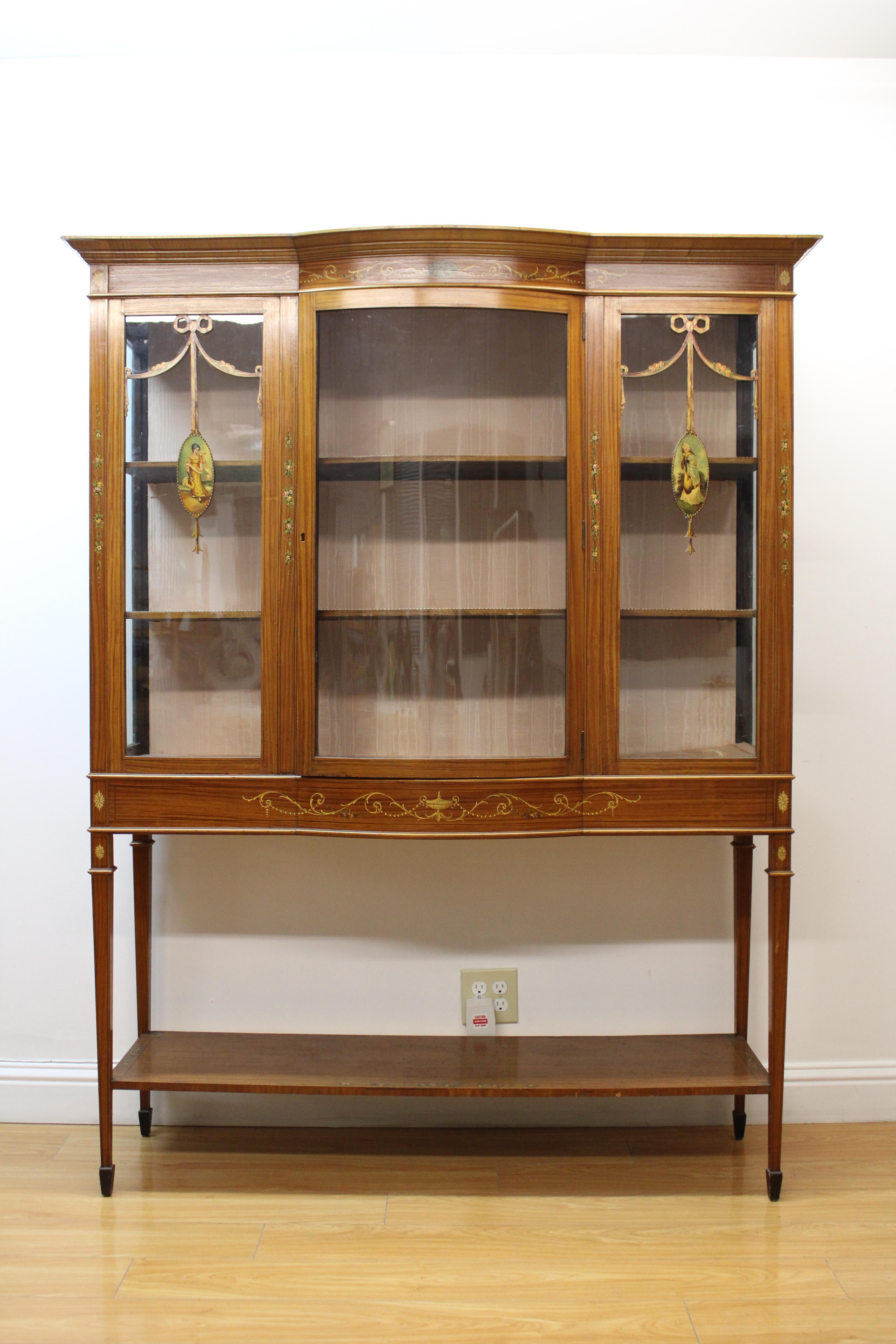 Beautiful Edwardian cabinet with hand painted  floral motifs and women figures on wood. 

Cabinet has 3 glass panels--no key, lock has been removed.

