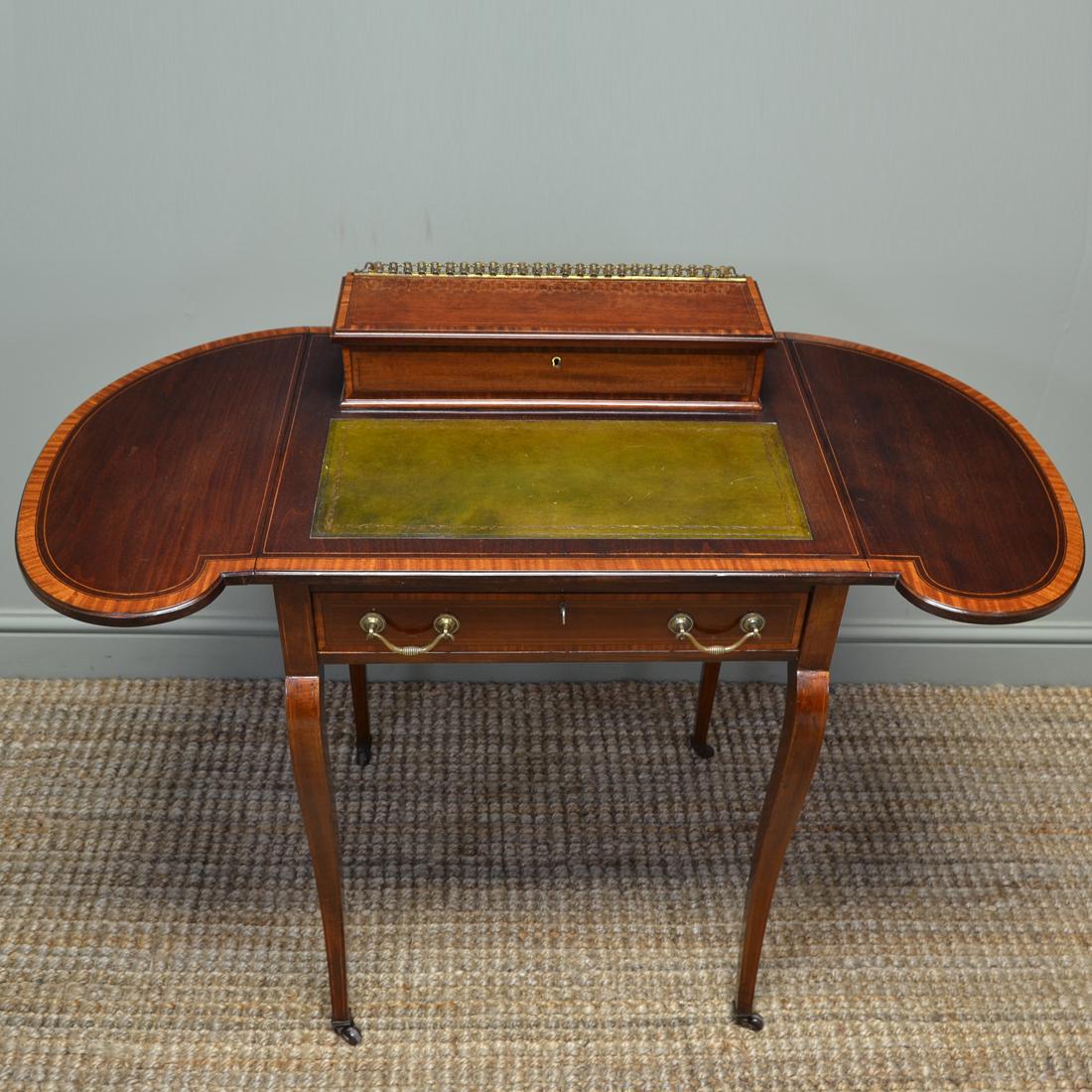 Stunning Maple & Co Edwardian inlaid mahogany antique writing table
 
Constructed by the renowned cabinet makers Maple & Co, this stunning writing table dates from circa 1900 in the Edwardian period. With a green tooled leather writing insert and