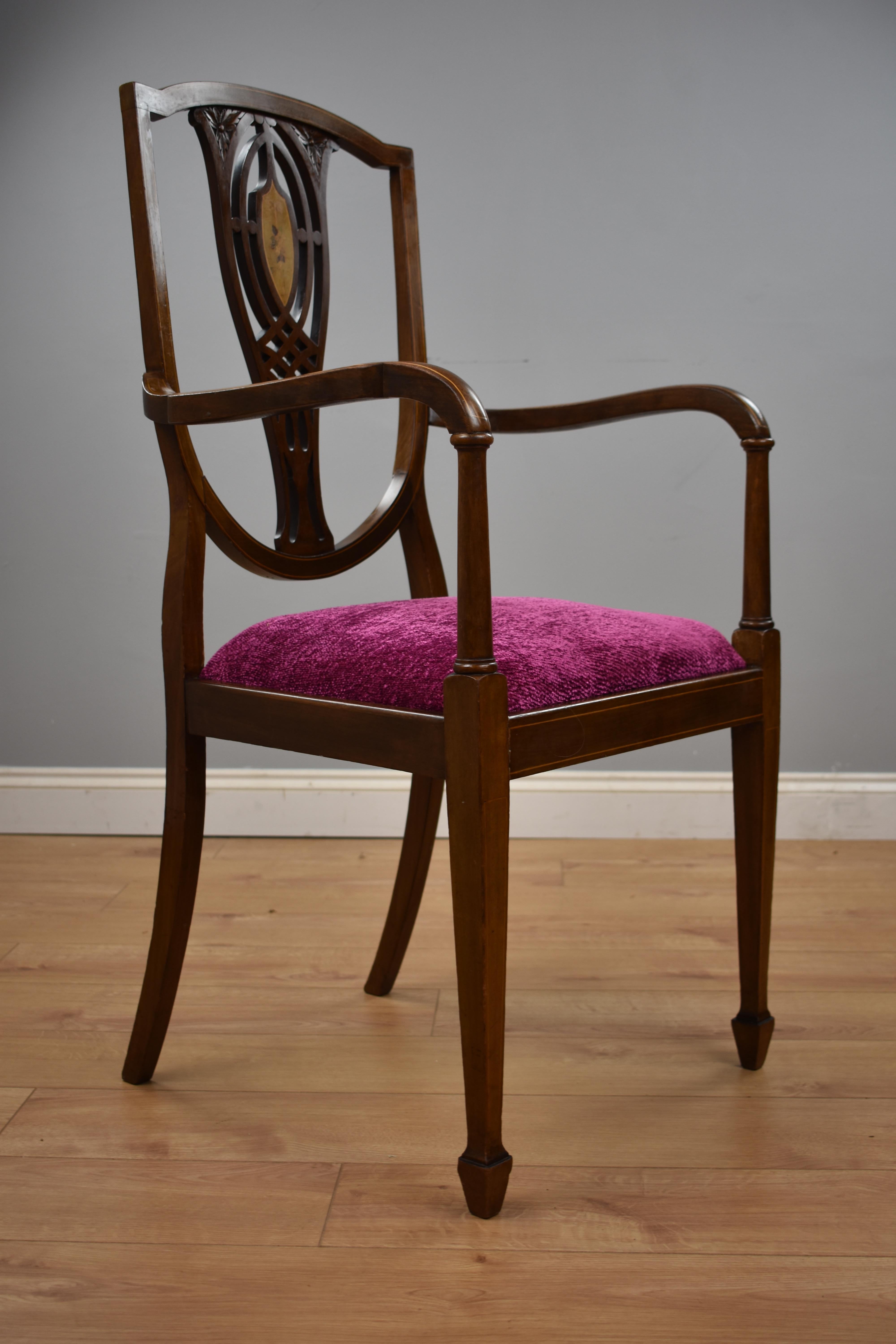 Edwardian inlaid mahogany chair in good condition, the chair has a nice floral inlay to the back with upholstered drop in seat standing on tapered legs.
