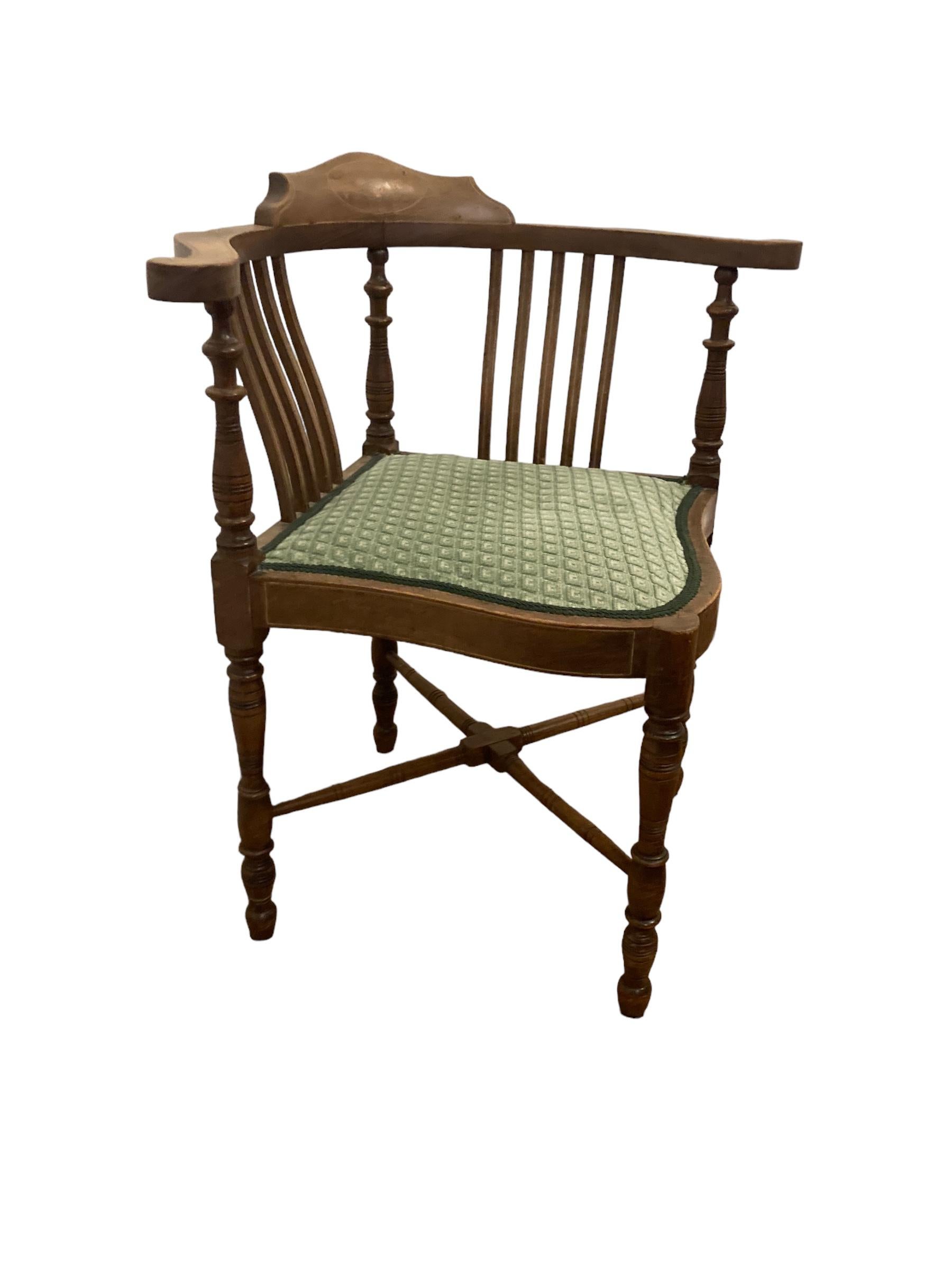 Edwardian Inlaid Mahogany Corner Chair. Shaped back with floral detail.Four turned Legs with X stretcher, Olive green seating which is typical for the time. This Chair is in original and great sturdy condition. A great example of Edwardian