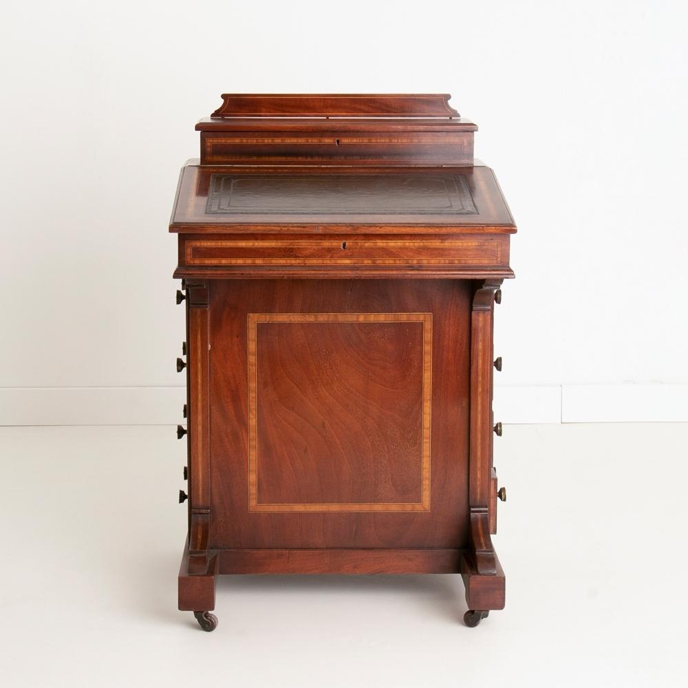 An antique Edwardian inlaid mahogany Davenport desk with leather writing top, stationary storage and drawers.